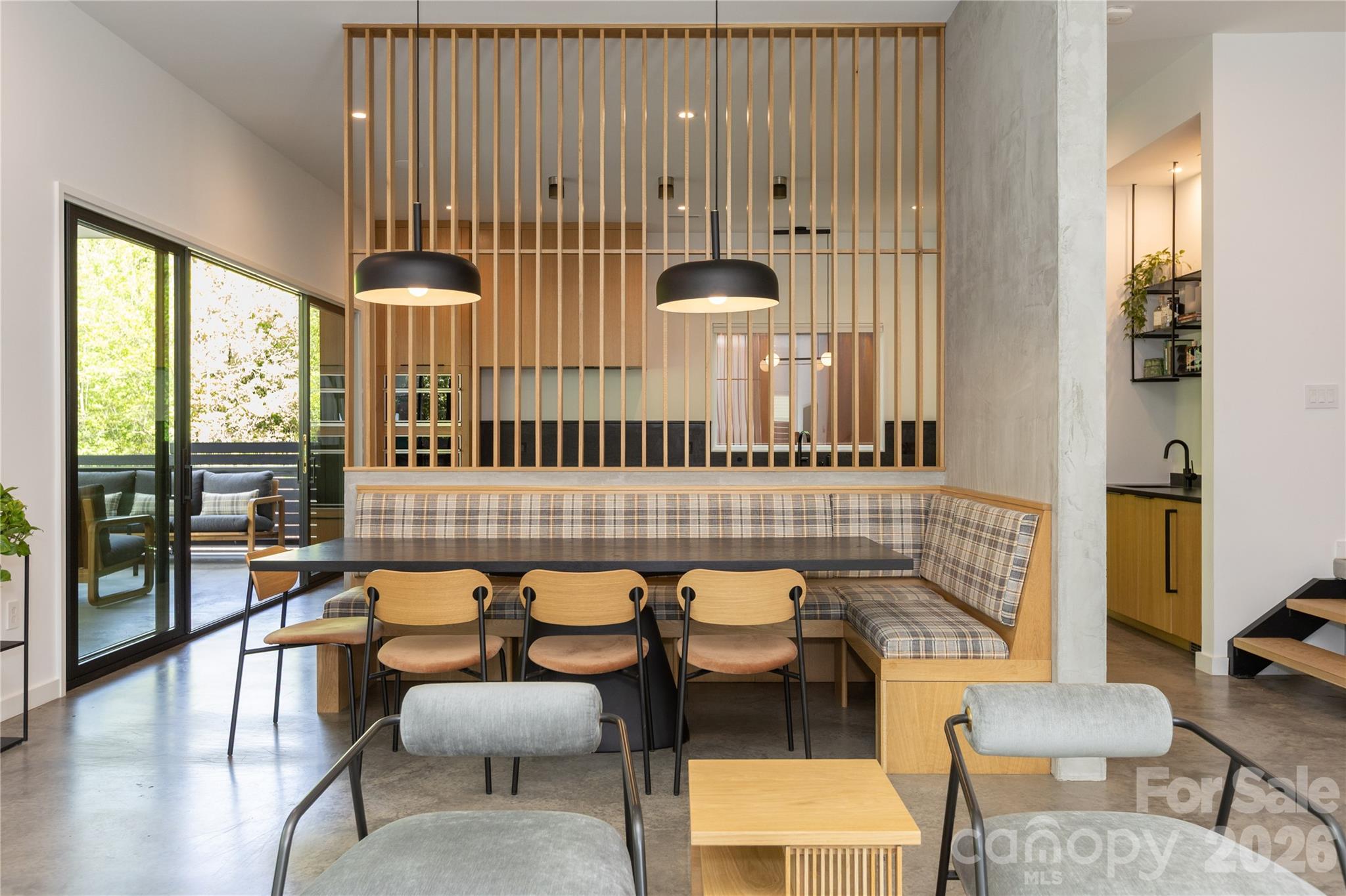 Striking modern residence located in Charlotte’s vibrant NoDa Artist District. Constructed in 2023 by renowned builder Peter Vasseur Homes and thoughtfully designed by Woodruff Architecture, this one-of-a-kind home was curated with design and art in mind, offering a sophisticated backdrop to showcase both everyday living and statement pieces.
Set on a generous lot, this 5-bedroom, 4-bath home seamlessly blends clean architectural lines with warm, organic materials. From the moment you enter, you’re met with a sense of intentional design, where wide plank white oak floors, polished concrete surfaces, and rich mahogany accents create a refined yet inviting atmosphere.
The open-concept living spaces are both functional and inspiring, anchored by a chef’s kitchen complete with custom cabinetry, a dedicated scullery, and thoughtfully integrated beverage stations. Expansive walls and carefully considered sightlines provide the perfect canvas for art, while large windows invite natural light to enhance every detail.
Each space throughout the home has been elevated with custom finishes, including designer lighting, a statement staircase, and tailored storage solutions. Modern conveniences such as smart home systems, spray foam insulation, and power blinds ensure comfort and efficiency without compromising style.
The three-car garage is equipped with EV charging in every bay, reflecting a forward-thinking approach to modern living.
Herrin Ave is more than a home, it is a curated experience where architecture, design, and lifestyle converge in one of Charlotte’s most dynamic and evolving neighborhoods.