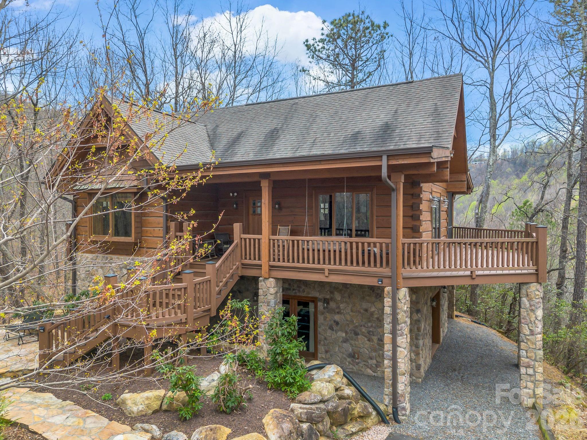 Escape to the serenity of 294 Verbena Lane, a storybook mountain cabin nestled in the gated community of Creston, just a short drive from the charming downtown of Black Mountain, NC. This meticulously maintained home offers a perfect blend of rustic elegance and modern comfort, providing over 2000 square feet of beautifully designed living space across three levels. The main level features a warm and inviting atmosphere with an open living area and vaulted ceilings, perfect for gathering by the fire or entertaining guests. The primary bedroom and a full bath are also on the main level. The upper loft functions as a second bedroom. The walkout basement has plenty of storage, a full bathroom, and a generous bonus room that is currently used as a game room. It could also be used as a hobby space, media room, bunkroom, or could be reconfigured to accommodate another private bedroom. This log home really shines when it comes to outdoor living space. The deck has recently been redone with Trex decking, and there is a screened porch off the living room. The main deck wraps around on three sides, and there is even a grilling deck off the kitchen. You can also enjoy the stone patio with outdoor fireplace! As a community, Creston is known for its commitment to preserving the natural landscape, offering residents access to hiking trails and an incredible community center with a dog park and fitness center. Creston is surrounded by Foothills Land Conservancy and Pisgah National Forest, making this gated community one of the most beautiful and natural neighborhoods in Western North Carolina. Enjoy a quiet lifestyle while remaining close to the vibrant arts, dining, and shopping of Black Mountain and nearby Asheville. Whether you are looking for a full-time residence or a seasonal getaway, this cabin at 294 Verbena Lane is a mountain oasis waiting for you. This lot is designated a "CC" lot (Cabins at Creston), meaning short-term rentals are allowed with a 3-night minimum stay. Roof has been recently inspected and is in good shape.