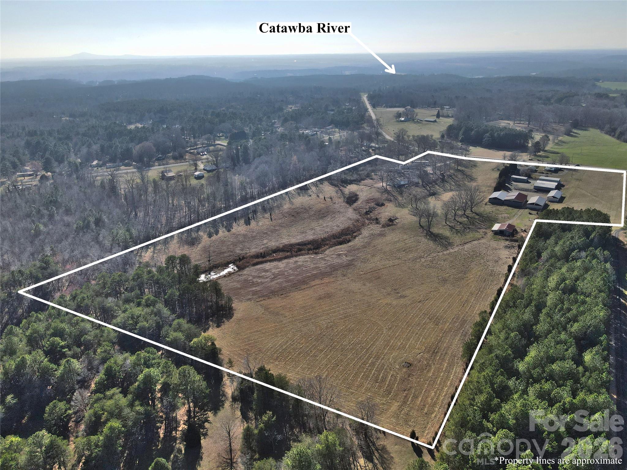 Looking for a beautiful place to build? A place to have your own mini-farm? Easy access to lake life? Only 1.8 miles from Lake Norman/Catawba River area, marina. This property has easy access to 1-40, 1-77 for commutes to Hickory, Mooresville, Charlotte and the Lake Norman area. If you are tired of the suburbs and subdivisions, here is your chance! Very unique property that includes two parcels totaling more than 30 acres of beautiful rolling land accompanied by a 1940 residence, a natural spring-fed pond, an abundance of storage options that can accommodate large equipment, including enclosed buildings and three-sided storage bays. Small dairy barn, an old air strip. Buildings include 4 bay enclosed garage unit(l000'), metal equipment/shop(2400'), pole shed w/metal roof (2160'), equipment shed (2880'), equipment shed (3800'), livestock shelter & barn (1500'). Section of the property has accommodated up to 12 singlewide homes in the past, providing income from the lot lease to homeowners. There are four units currently on the property and being rented. Those rentals are month to month according to the seller.  The county is not authorizing addition of future singlewides to the property.   Some fenced pasture areas. Two wells, some beautiful building sites, a ready-made mini-farm!!Selling AS-IS. You won’t find 30 acres of land within 2 miles of Lake Norman often!!