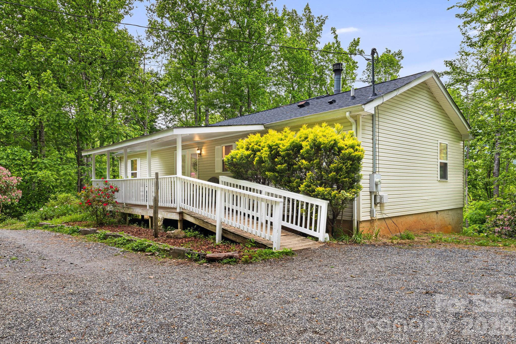 Nestled on 3.37 private acres, this property offers comfortable one-level living just 10 minutes from downtown Sylva and under 20 minutes from Waynesville or Western Carolina University. With almost $100k in recent improvements, this property is a must see and offers excellent value. 

The main floor features a primary owner's suite with a walk-in closet and private bath, along with two additional guest bedrooms and a second full bathroom. A spacious living room, anchored by a cozy wood-burning fireplace, provides the perfect setting for cool mountain evenings.

The home expands into a large basement on the lower level, which includes a private entrance and a full bathroom for added flexibility. There is also a ton of unfinished space in the basement for storage or potential expansion. Outside, the grounds are equipped with a chicken coop and numerous outbuildings suited for hobbies or extensive storage.

A standout feature of the home is the back porch, a peaceful sanctuary that boasts breathtaking views of the Smoky Mountains. Surrounded by forested acreage, this retreat is filled with the sights and songs of native birds, offering a true escape into nature.

The surrounding land is a gardener's dream, showcasing flowering tulip poplars, vibrant flowering trees, and evergreens that provide year-round beauty. The mini-orchard includes a variety of apple, cherry, peach, and plum trees, as well as fig trees and berry bushes in raised beds. 
This location perfectly balances seclusion with accessibility, situated just minutes from the Blue Ridge Parkway and its many hiking trails. Residents can enjoy the quiet of the mountains while remaining close to all that Western North Carolina has to offer.

ATTN BUYERS!!! Motivated Sellers offer $3,500 towards your closing costs/ buy down the rate!