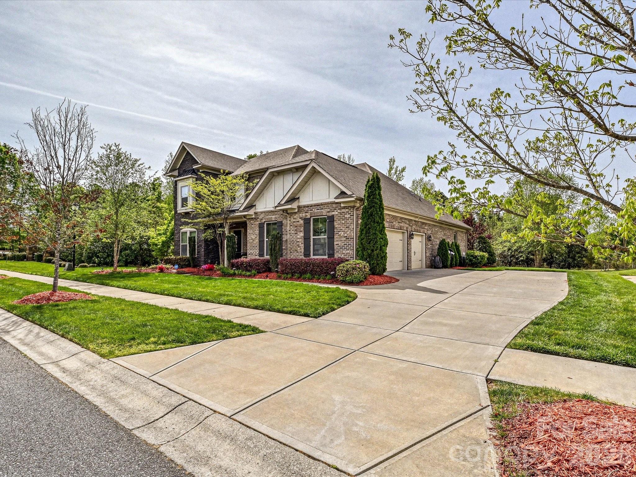 NEW FANTASTIC PRICE!!!
This home below 1.3M is an incredible deal. 
Welcome to unparalleled luxury in the highly sought-after Falls at Weddington, zoned for a highly rated, top-tier school district. As a former model home, this stunning full-brick estate masterfully blends sophisticated elegance with a warm, inviting ambiance, featuring a premium speaker system integrated throughout the home for effortless entertaining. The expansive main level boasts a seamless open floorplan, featuring a breathtaking gourmet kitchen with a sprawling island and walk-in pantry that flows effortlessly into the breakfast area and a magnificent great room anchored by a cozy fireplace. Entertain in the formal dining room or work with ease from the dedicated executive office. The lavish primary suite, conveniently located on the main floor, offers a private oasis complete with spa-like finishes and expansive walk-in closets. An additional main-level bedroom and full bath provide ideal, accessible accommodations for guests.

Ascend to the upper level to discover three generously sized bedrooms, two full bathrooms, and a versatile media room perfect for private movie nights. Step outside to your serene exterior retreat featuring a beautifully crafted screened-in porch and an open patio. The meticulously manicured, level backyard is effortlessly maintained by an in-ground irrigation system. Complete with a pristine 3-car side-load garage, an expansive laundry room with a drop zone, and access to resort-style community amenities including a clubhouse, fitness center, and pool. This is more than a home; it's a lifestyle.