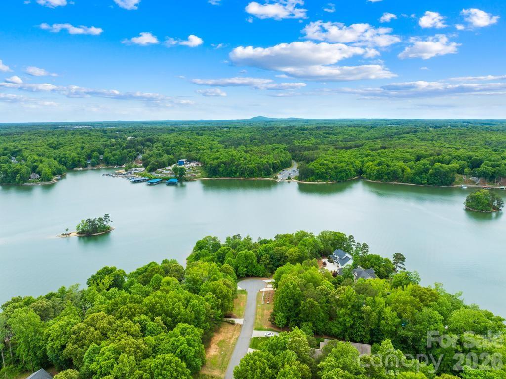 Discover an extraordinary opportunity to create an estate in the prestigious gated Harbor Watch community on Lake Norman. Positioned at the end of a quiet cul-de-sac, this exceptional .72-acre waterfront homesite offers approximately 174 feet of shoreline along the main channel, delivering expansive water views and an unmatched sense of privacy. The sloping topography is ideal for a walk-out basement design, allowing you to fully capture the beauty of the lake while seamlessly blending indoor and outdoor living. With no time limit to build, you have the freedom to bring your own builder and craft a custom home with no timeline. Based on a recent soil evaluation, Lots 27 and 28 (268 S Harbor Watch Dr.- MLS #4375882) are being marketed together to create a 3-4 bedroom estate, resulting in an impressive 1.53 acres and approximately 363 feet of shoreline- an almost unheard-of footprint on Lake Norman.   Surrounded by natural beauty and in one of the area’s most desirable gated communities, this property offers the perfect balance of seclusion, luxury, and lifestyle. Experience the serenity of waterfront living while remaining just moments from everything Lake Norman has to offer. Harbor Watch offers a boat storage lot, community boat launch and day docks, picnic area, and catch and release stocked ponds.