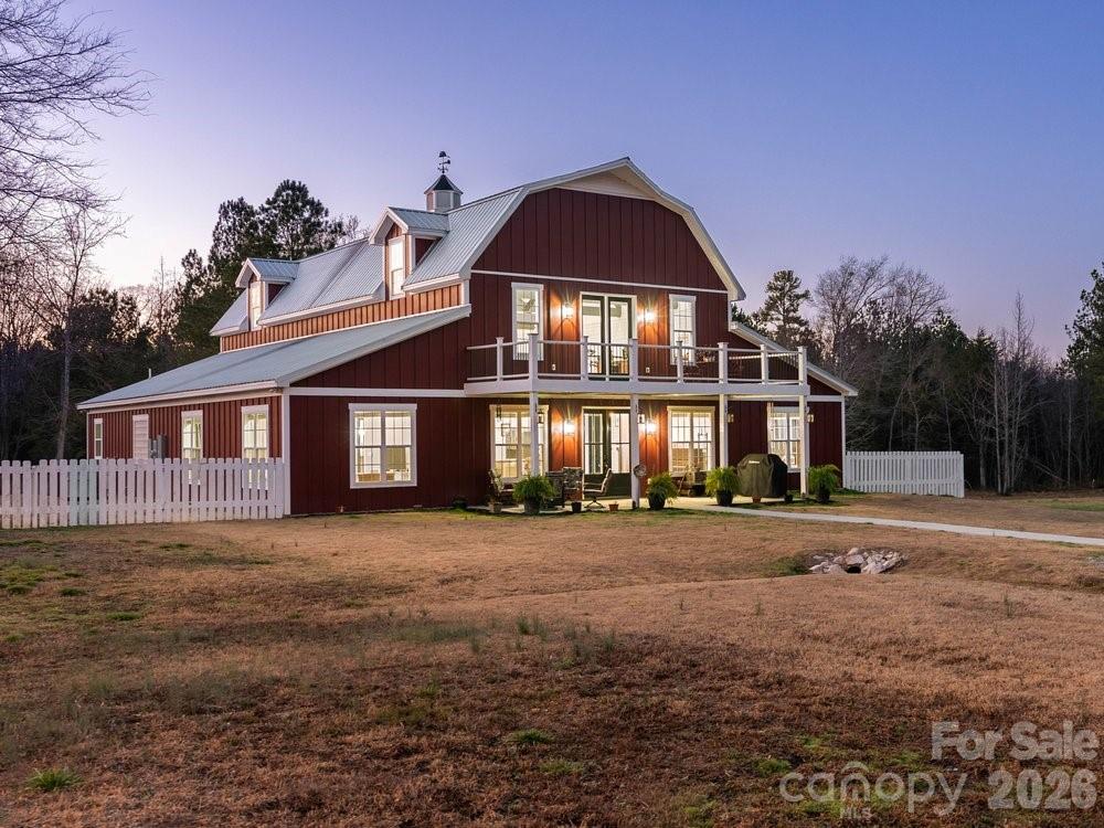 A true countryside dream set on 10.36 equestrian-ready acres. This exceptional property features two fenced pastures, a fenced backyard, and a Barn Master metal-framed barn with three stalls (expandable to 4–5), tack room, spray-insulated ceiling, and floor drain ready for a wash station — perfectly suited for horses, hobby farming, or simply embracing wide-open country living. A charming chicken coop completes the farmstead feel.

Built in 2021, the thoughtfully designed barndominium blends rustic warmth with modern efficiency. The soaring 28-foot ceilings, exposed trusses, and natural gas fireplace create a breathtaking main living space. The kitchen offers quartz countertops, gray cabinetry, tile backsplash, and bay windows that fill the home with natural light. The primary suite features dual vanities, a tiled shower, soaking tub, and heat lamp, while two additional bedrooms sit privately on the opposite wing. Upstairs, a loft overlooking the stunning home with access the Trex porch that overlooks the rolling acreage.

With spray foam insulation, metal roof, Hardie board siding, tankless water heater, dual HVAC systems, and generous attic storage — this property delivers durability, efficiency, and timeless country charm.

Where open skies, peaceful pastures, and modern comfort come together — this is countryside living at its finest. Within one hour to CLT airport, 3 Vet clinics within 20 miles,  under 10 minutes to MUSC medical center, restaurants and grocery shopping!