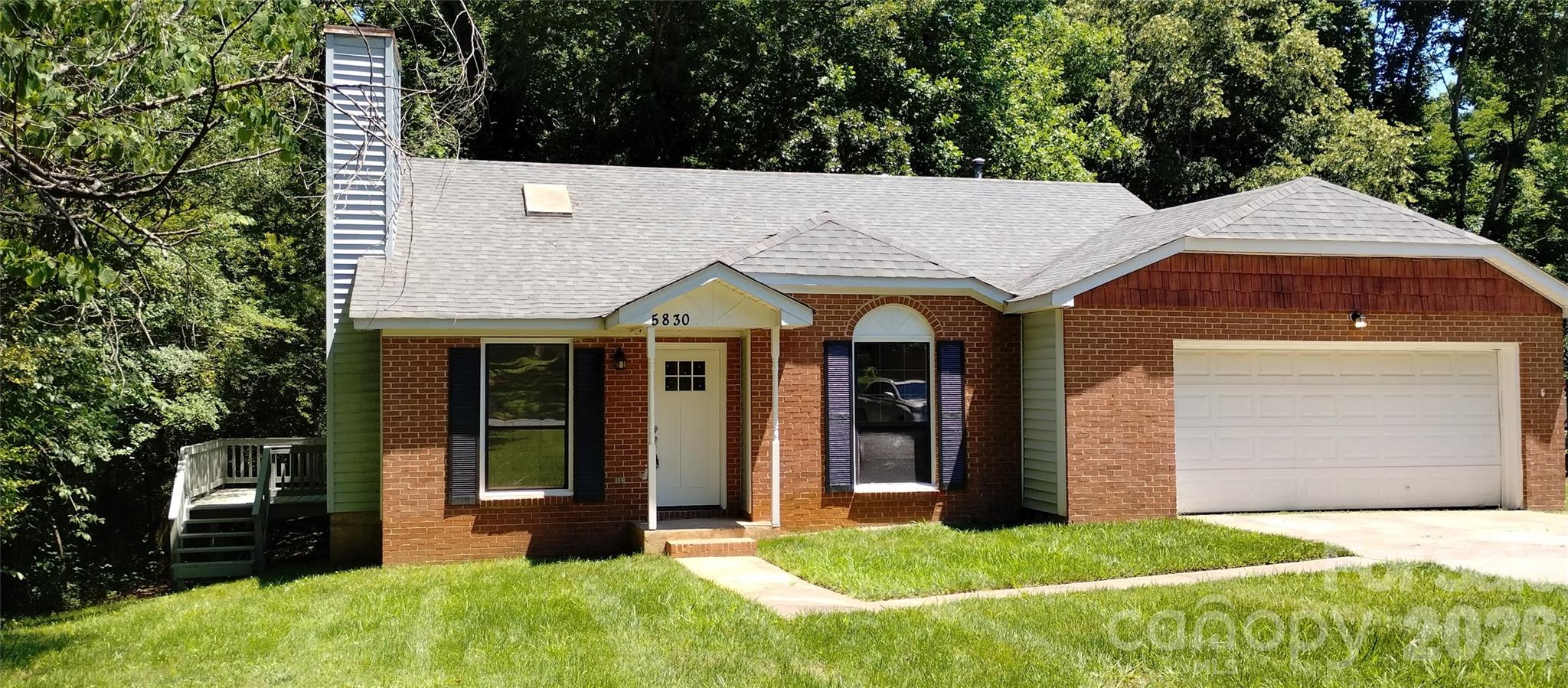 No HOA!  Welcome to 5830 Stone Bluff Dr. in Charlotte, NC! This beautifully updated three bed two full bath home offers a fresh and modern living experience. The kitchen features brand new quartz countertops and a stylish tile backsplash, perfect for any home chef. Both bathrooms have been completely refreshed with new vanities, new tile, and new toilets, and a new bathtub in the main bathroom, providing a spa-like feel. This home is move-in ready and waiting for you to make it your own!

The main living area features a fireplace that serves as a warm focal point that opens directly to a side deck. The kitchen and dining area are combined, providing an open and practical space for daily living. The primary bedroom offers privacy and includes its own full bath. Two additional bedrooms are located close to the hall bath.  They are ideal for a growing family, guests, a home office, or possibly a creative retreat. A second full bath serves these rooms and the main living areas.

An attached 2-car garage off the kitchen has some built in shelfing and a work table.  The driveway is long and has parking for multiple vehicles.  The yard is large and could be fenced in.