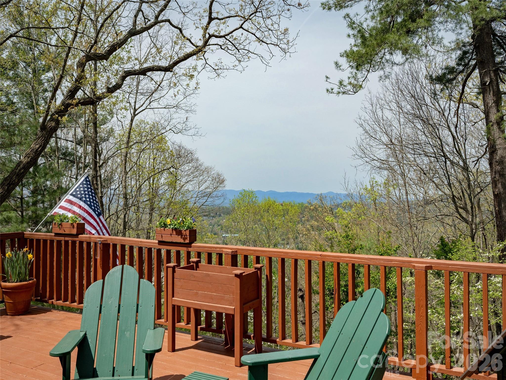 Enjoy life in the mountains in this custom designed, one owner home on Sunset Mountain.  Located just 10 minutes from the restaurants, shopping, and cultural offerings of Downtown Asheville, this home offers a vacation-like atmosphere surrounded by nature, privacy, and long-range views. The property even features a small creek fed by a natural spring. Multiple decks on two levels allow you to spend time outside and enjoy the nice weather.   Included is a Big Green Egg grill and a hot tub.  Built with high-quality materials—including 6-inch walls, copper guttering, cedar siding and Andersen windows—the home has been meticulously maintained. Updates within the last two years include a new roof, fresh exterior stain, updated bathrooms, and an updated kitchen with new appliances. Additionally, a new Trane heat pump was installed last year for the main levels. Special features include wood floors on the main level except for marble tile in the kitchen, cathedral ceiling and a palladium window in the dining room, a garden window in the kitchen, cathedral ceiling in the primary bedroom, a sunroom off the primary bedroom, a wood burning Jotul stove (complete with a supply of wood) in the living room, and a propane gas stove in the family room. A few steps from the lower deck is an auxiliary building with electricity that is used for a workshop.  It would also make a great studio or playhouse.  There is covered parking for 2 vehicles, plenty of room for additional vehicles and ample turn around space. For your piece of mind, a one-year 2-10 Supreme Warranty is provided. This might be a perfect home in the mountains for you.