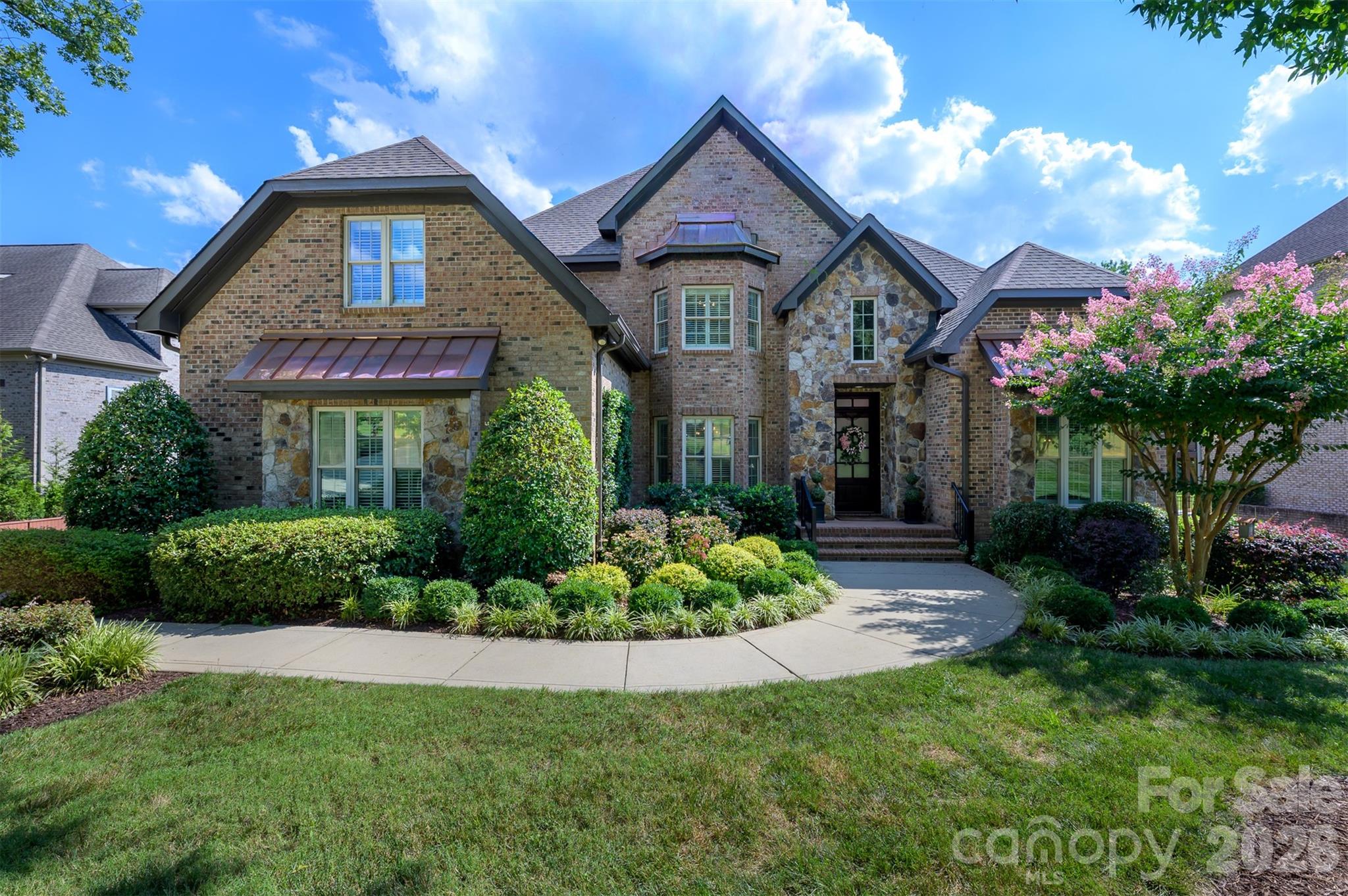 Welcome to this exceptional 4,300+ square foot home in the prestigious gated community of Providence Downs South, one of Union County’s most sought-after neighborhoods. Perfectly positioned on a premium lot backing to HOA-owned land, this home offers an unmatched level of privacy with tranquil wooded views that remain untouched. The spacious well organized floor plan features five generously sized bedrooms, including a luxurious primary suite on the main level wth sitting area, large walk in closet & primary bath. The updated kitchen showcases new stainless steel appliances (2026), abundant cabinetry, and opens seamlessly to the main living areas, creating the ideal gathering space. Upstairs find 4 spacious secondary bedrooms, each connected by Jack/Jill bathrooms, along with a bonus room that offers possibilities for a media room, playroom, or home office. Outside find your own private backyard retreat featuring an outdoor kitchen with a new gas grill (2025), a cozy wood-burning fireplace, and a custom putting green—perfect for relaxing or entertaining year-round. The investment in landscaping shows and provides an exceptionally serene backyard setting. Additional highlights include a three-car garage, a new roof (2025), and both HVAC systems replaced in 2023 (upstairs) and 2025 (downstairs), offering peace of mind for years to come. Experience luxury living, outstanding amenities, top rated schools and an unbeatable location in Providence Downs South, just minutes from shopping, dining, and everything the Charlotte has to offer.