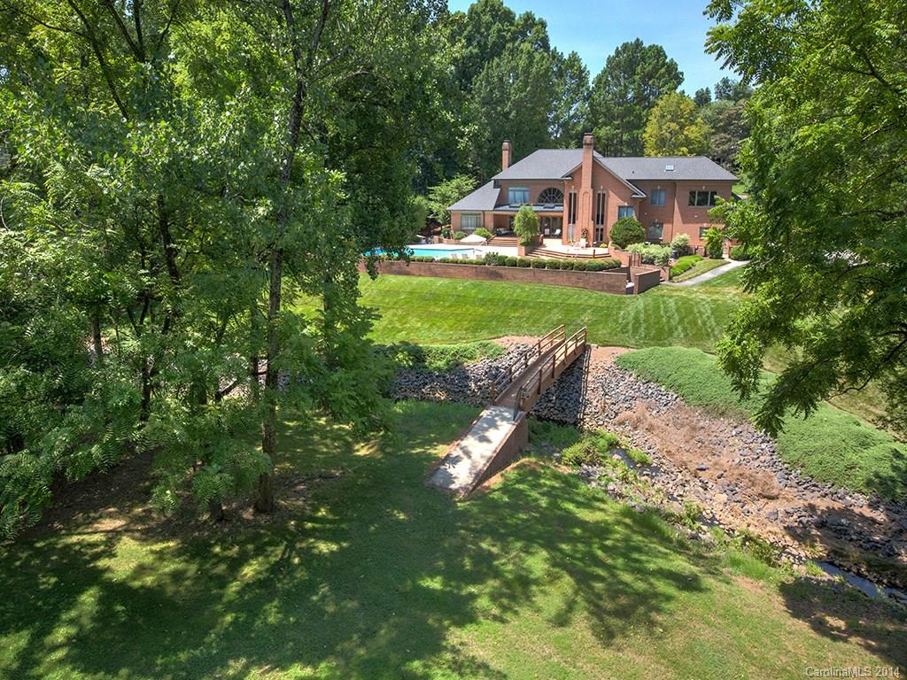Unleash the imagination and the options are endless. A solid & well maintained residence that would benefit from being 'de-1980-fied'. Or, if you are looking for the best homesite in Charlotte, it can be considered for your dream mega new build. Sits proudly on one of the larger lots; a beautiful, idyllic 2.5 acres in the premier 24hr guard-gated, Seven Eagles. A rare to come by offering that hosts simply stunning views up the 7th fairway of Quail Hollow, home of the WF Championship. Master down