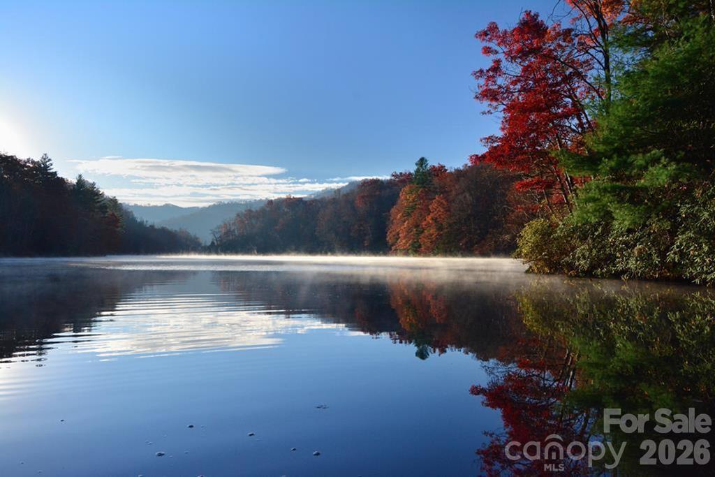 Price Improvement. MOTIVATED SELLER.  Build your mountain lake home on this beautiful lot at Cedar Cliff Lake. This property is located near the end of the lake where the water is deep, and the lake is wide. Duke Energy owns the shore line around this lake and has given the owner verbal permission to build the trail from the lot down to the lake and to build the boat dock which is larger and grandfathered in to accommodate motorboats. Cedar Shores common area includes a boat rack and a 4 slip marina. Cedar Cliff Lake is also considered the best lake around to paddle on. A paved road leads to Lot 5's gravel/grassy driveway. Just 12 minutes to WCU and a short distance further is Ingles, CVS, Lowes, restaurants, schools and Sylva. If you head south, Cashiers is 17 miles away.  Enjoy all the mountain adventures around - Bryson City, Cherokee, Waynesville and Asheville.