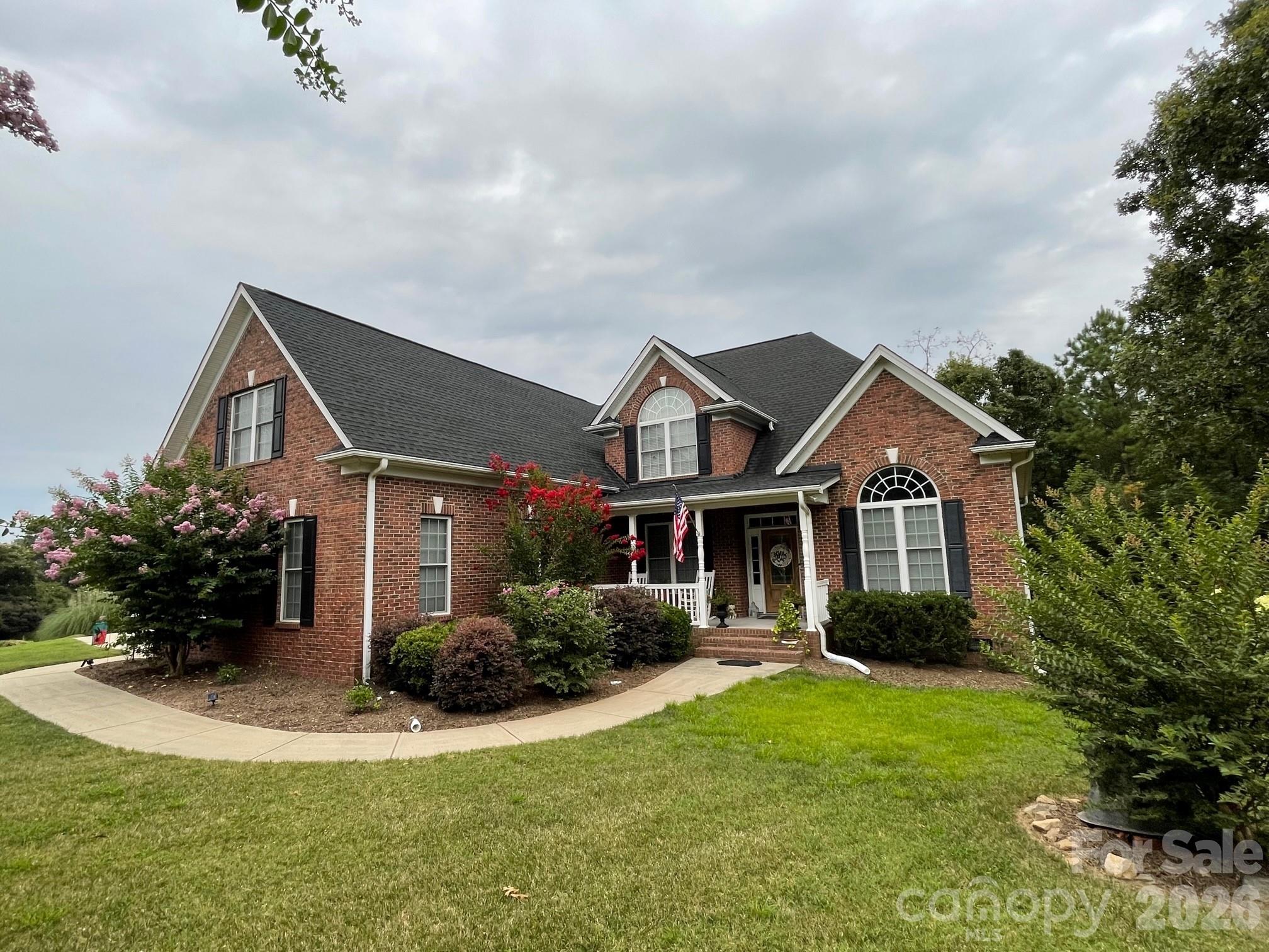 Welcome to 106 Spinnaker Bay Lane in the prestigious Masons Crossing community of Lake
Wylie, SC! This stunning all-brick custom home offers approximately 2,983 square feet of
thoughtfully designed living space on a desirable corner lot—with NO HOA and located in the
highly sought-after Clover School District. Step inside to gleaming hardwood floors that
flow throughout the main level, highlighted by a dramatic two-story vaulted foyer and family
room featuring a cozy gas fireplace. The elegant formal dining room showcases a vaulted ceiling,
wainscoating, picture molding, and an impressive Palladian window that fills the space with
natural light. A formal living room provides the perfect setting for a home office or sitting
room.The spacious kitchen is designed for both everyday living and entertaining, featuring
abundant cabinetry, granite countertops, tile backsplash, stainless steel appliances, a raised
breakfast bar, and a sunny breakfast area. Off the family room you will find beautiful french
doors that open to a huge screened porch overlooking an expansive, private backyard—ideal for
relaxing or hosting family and friends. The luxurious main-level primary ensuite features a
double tray ceiling and a newly installed custom walk-in closet. The beautifully appointed
primary ensuite bath offers a beautiful classic freestanding soaking tub, an oversized walk-in
shower, dual vanities and tile flooring. The main level laundry room and powder room have been
updated recently as well. Upstairs, you'll find a hardwood hallway, two generously sized
bedrooms, a full bath, and an expansive bonus room that can easily serve as a fourth bedroom,
media room, or playroom. Additional highlights include a 3-car garage, exceptional storage, and
a prime location just minutes from top-rated schools, shopping, dining, and Lake Wylie
amenities. With this home being centrally located, you have quick access to other areas such as
Clover, Gastonia, York, Rock Hill, Fort Mill and Charlotte. Don't miss this rare opportunity to
own a beautifully updated custom home in one of Lake Wylie's most desirable locations!
Property is zoned for the newly built Lake Wylie High School. You will know you “Are Home”
as soon as you walk through the door! Make it yours today!