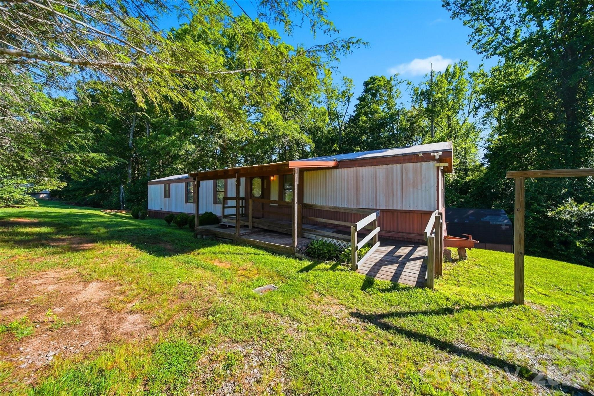 This three bed one and a half bath manufactured home is ready for a new owner! Enjoy 3/4 of an acre on a corner lot. Covered front porch and accessible ramp. Storage building remains! Located close to Connelly Springs Road and I 40.