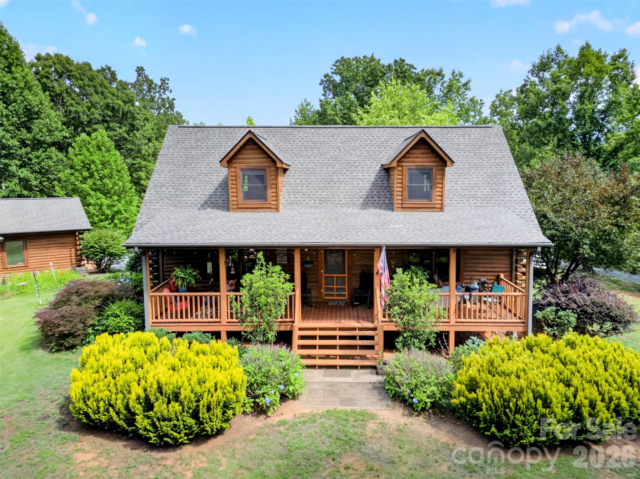 Beautiful Log Home Sitting On Almost 9 Acres!

Upon entering the home, you will find a great, functional floorplan featuring a large living area with cathedral ceilings, a large stone fireplace, multiple points of access to the large rear deck and the primary bedroom suite on the main level of the home. Also on the main level, you will find an open, updated kitchen, a laundry closet, another half bath in the common area and great features like granite countertops and hardwood floors throughout.  When heading up the stairs you will find two more spacious bedrooms on either side as well as another full bathroom in the hallway. Outside of the home, you will find wooded privacy in all directions, an amazing two car detached garage and another separate building that has many different possibilities such as extra storage space or a great workshop. For someone looking for acreage and privacy while also wanting a turnkey living space, this property will fulfill of all of those needs. Call to schedule your showing today!