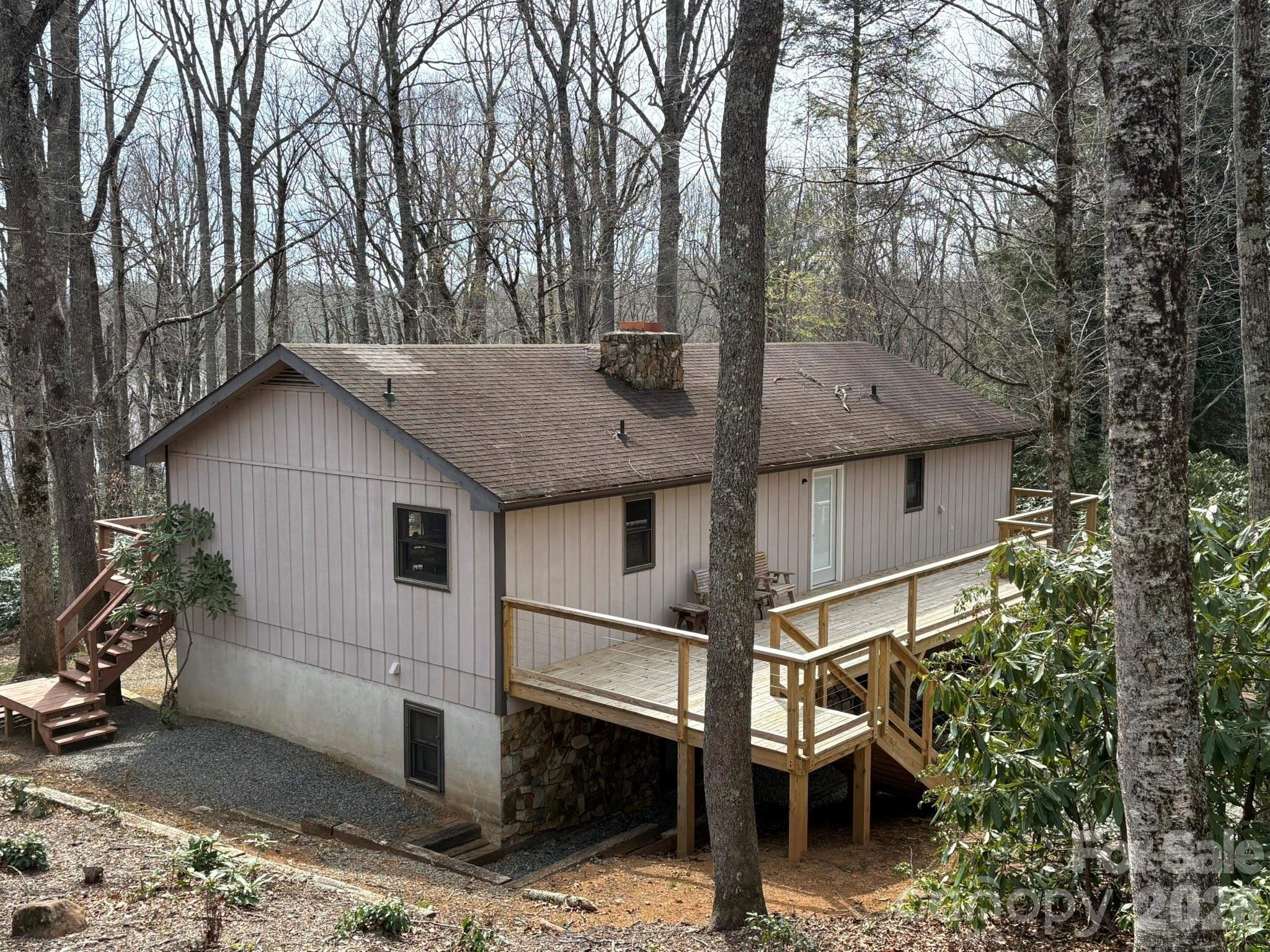 Four bedroom, two and half bath home in the Blue Ridge Mountain resort community of Linville Land Harbor. Located near the Land Harbor lake and recreation center, you can enjoy walking to the heated outdoor pool during summer months. Home main entrance on top floor via new deck on the front of the house. Original entry was via the lower level where you find two bedrooms, one with en suite bath, small office alcove, a half bath and the garage. Upper level has kitchen, dining room, living room, two bedrooms and one full bath. Large stone wood burning fireplace, great closet space and solid Brazilian Teak and Oak floors through out the top level. Expansive deck running the length of the home off upper level with seasonl view of the lake. Two fireplaces! Plenty of parking. Home is being sold unfurnished. Land Harbor has golf, pickleball, tennis, fishing, hiking/walking trails, dog park and so much more...truly a great spot for your vacation or year-round living.