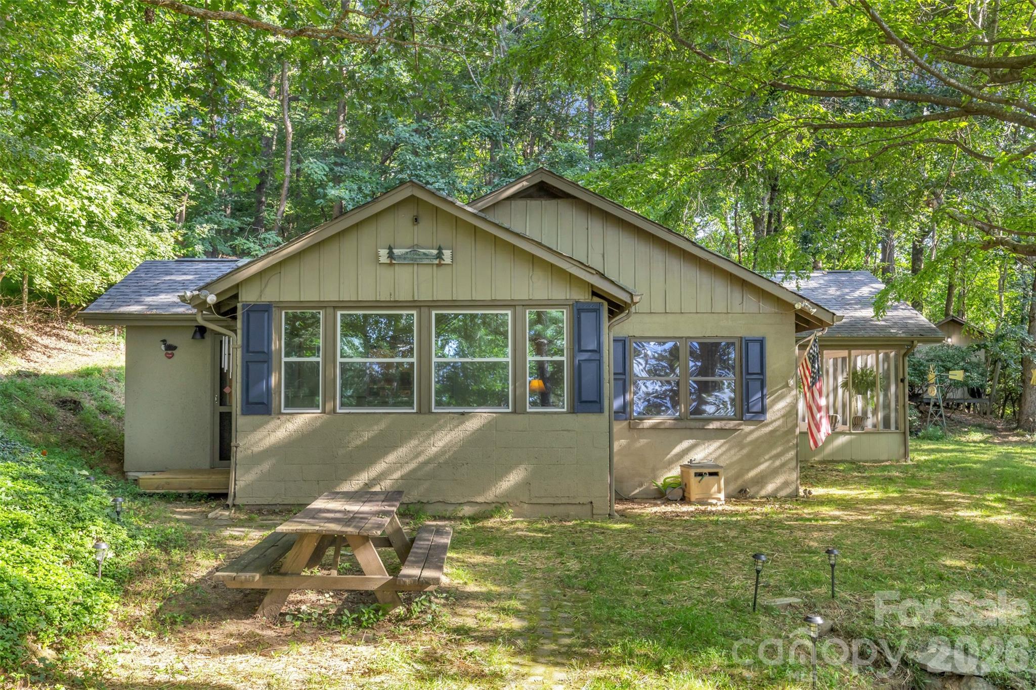 WOW! Long range views from this original 'Caretakers Cottage' to the original Camp Skyuka, now a private mountain home community! Just steps across the street to the Community pond with diving docks for Swimming & Fishing & docks for just soaking up the sun. This 3 bedroom, 1 bath cabin on .79 acre. has been well loved by the same family for the last 30 years! Enjoy the spacious screened porch to watch the sunrise, nap/read on sleeping couch, host parties or just watch the deer & wildlife stroll past. Sit by the cozy wood burning stove in living/dining room or sip your morning coffee in the adjacent sunroom off the ample kitchen. 2 good sized bedrooms, one office or use as bunk room & a mud room round out this mountain getaway. A little TLC, you can make this quaint cottage your very own! Camp Skyuka HOA amenities also include a Picnic Pavilion and tennis/pickleball court. Whether you’re looking to unwind with a good book, hiking, biking, horseback riding, theatre, dining out or shopping, this rustic cabin provides the ideal backdrop. Visit their website at CAMPSKYUKAHOA.COM for more information about this year round, active mountain community!