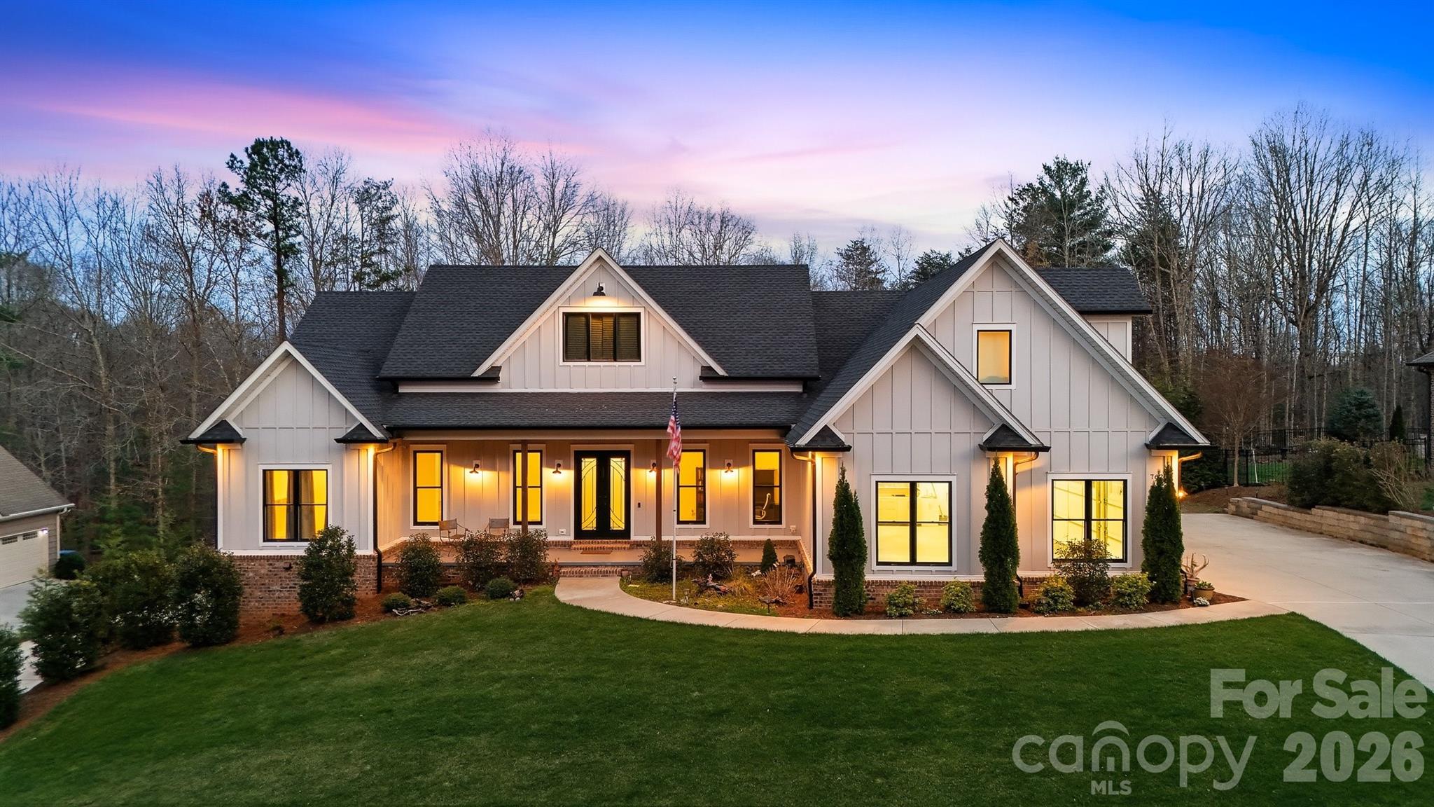 This stunning custom-built 2021 modern farmhouse offers 5,294 finished heated square feet of luxurious, thoughtfully designed living space in the highly desirable River Bend neighborhood. Perfectly situated in the Lake Hickory / Granite Falls area, this home provides convenient central access near US-321 and I-40.
The main level features an effortless open-concept layout ideal for entertaining, seamlessly blending the gourmet kitchen, dining area, and living room anchored by a cozy gas log fireplace. The chef's kitchen impresses with quartzite countertops, an oversized island, under-cabinet lighting, a walk-in pantry, premium stainless-steel appliances, a Thor gas range with an exquisite custom range hood, and a dedicated beverage refrigerator. Two bedroom ensuites grace the main level for ultimate convenience, complemented by a private office, ambient lighting throughout, and an additional bedroom ensuite on the upper level. 4 total bedrooms plus 5.5 bathrooms, in total.
The living room opens to your private oasis: a gas-heated saltwater pool and jacuzzi, enhanced by exterior lighting, surround sound, and a full irrigation system. 
The fully finished basement expands your living options with a spacious recreation/media room -prewired for surround sound, an additional bedroom, 2 full bathrooms, a kitchen, and a bonus room all accessible by a private entrance, a dedicated driveway, and a one-bay garage. Perfect for generational living. 
Practical luxury abounds with a main-level side-entry three-bay garage, Generac whole-house gas generator, central vacuum, whole-house de-humidifier, radon mitigation, hard-wired camera system, LiftMaster MyQ garage doors, hardwired Eero Mesh Internet, RV receptacle, and spray foam insulation throughout. Boat slips are located within River Bend for $50/month rental fee, as available.
This rare combination of modern elegance, thoughtful amenities, and prime location makes this home an exceptional opportunity near Lake Hickory.