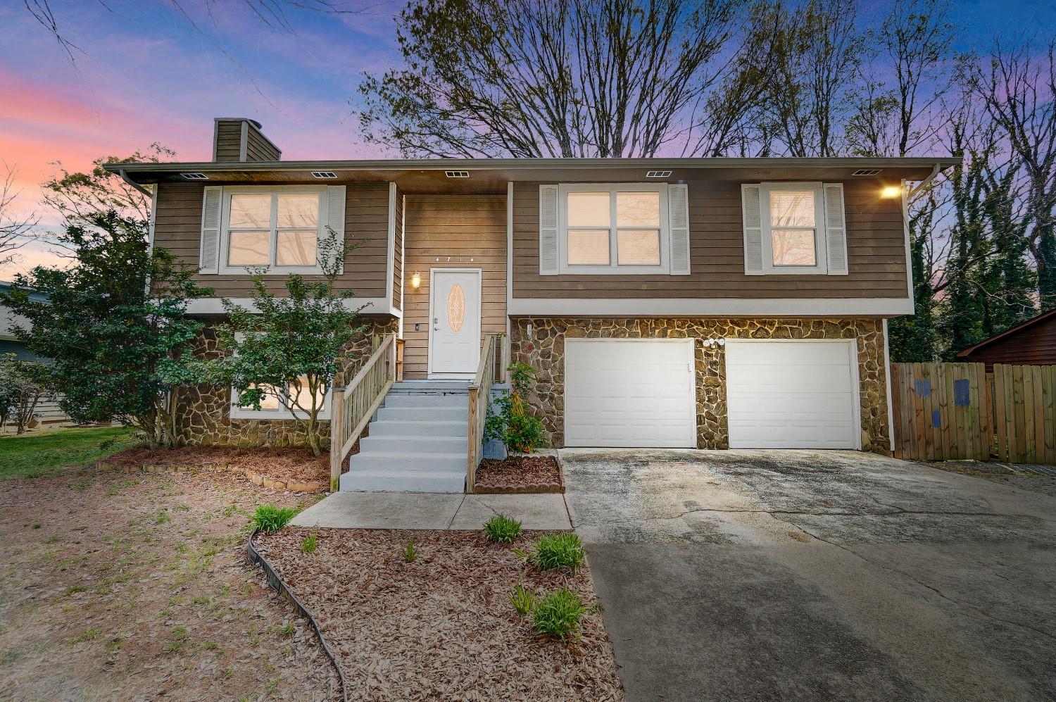 Welcome home to this move in ready 3 bedroom home minutes from shopping, dining, and major roadways.  Windows updated in 2021, roof and laminate wood flooring updated in 2022, and neutral paint, epoxy garage floor, and carpet updated in 2023.  Our favorite features include the large fenced yard with trees, bonus room with pool table in the lower level, molding, built in shelving, stone fireplace, deck, patio, ring door bell & security system, kitchen with painted cabinets, stainless appliances and tile backsplash, tiled bathrooms, pet nook, primary suite with walk-in closet and en suite bath, pull down attic, laundry room with separate utility room, long driveway for extra parking, extra large garage with room for cars, workshop, and gym and so much more.  Seller providing one year home warranty with First American.  Schedule your appointment to see for yourself today.