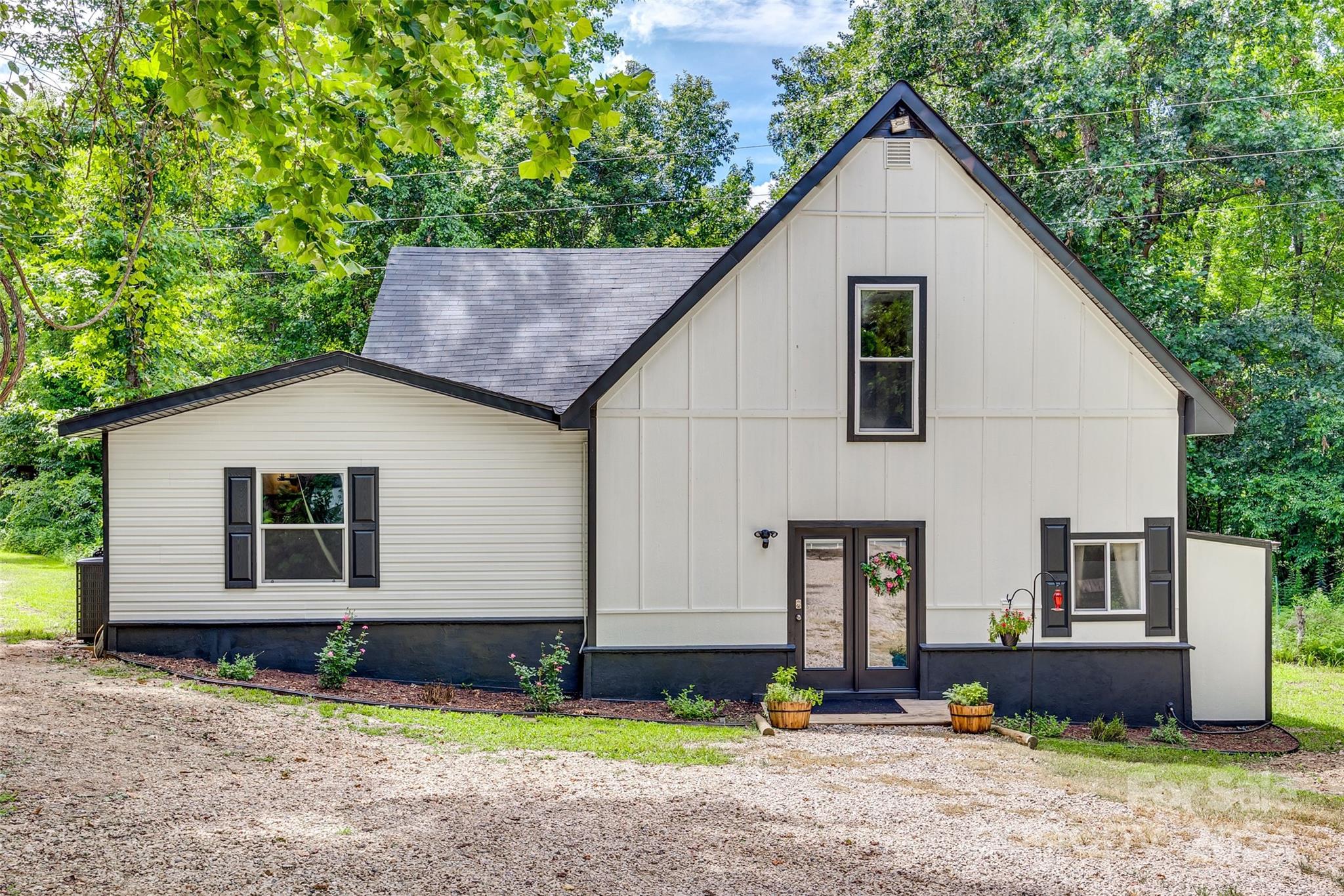 Welcome to your own private oasis on 5 acres of beautiful land, complete with a charming walking trail that winds through the property. This unique offering includes a remodeled main house and a cozy tiny house, providing endless possibilities for living and entertaining. The main house has an updated spacious kitchen and a massive living area. The primary bedroom has a large walk-in closet, a sunken tub, and a walk-in shower. Upstairs are two additional bedrooms and a Juliette balcony. New HVAC and well is 2 years old. The Tiny house is a delightful bonus, offering a cozy retreat for guests or a peaceful workspace away from the main house. With its own kitchenette and bathroom, this space is both functional and inviting.