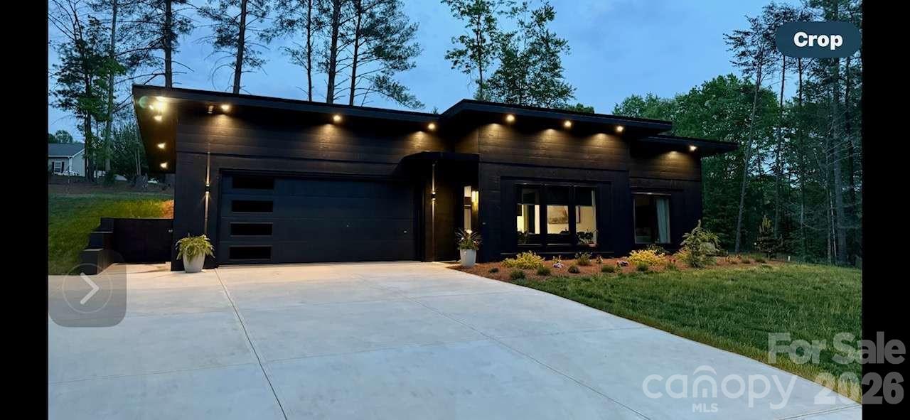Modern Oasis with Luxury Touches & Wellness-Focused Design This beautifully crafted 1,721 sq. ft. home, includes 600 sq. ft of the heated/cooled gym space, blends modern design with comfort and functionality. Set on a private acre+ teeming with wildlife, it was custom-built by a contractor-designer team with premium finishes throughout. The open kitchen features custom cabinetry, generous storage, and a walk-in pantry behind elegant glass pocket doors. The spacious primary suite includes dual closets and a spa-inspired ensuite with a floating vanity, concrete sink, and tiled walk-in shower. Enjoy polished concrete floors, multi-level lighting, and a whole-home ERV air filtration and dehumidification system—including in the garage and attic. The garage, finished to the same standard as the home, includes a full bath and is perfect for a gym, studio, or guest space. With no stairs and wellness at its core, this modern retreat offers peaceful, single-level living with style and intention.