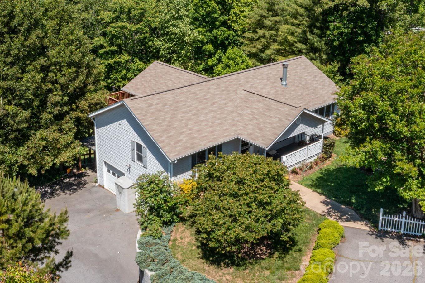 Location Location Location!Tucked at the end of a peaceful cul-de-sac in desirable Weaverville, 6 Arrowhead Lane offers the perfect blend of privacy, flexibility, and mountain charm—just 2.5 miles from Main Street’s beloved local spots like Well-Bred Bakery and Twisted Laurel, and very easy access to the Blue Ridge Parkway.

The main level welcomes you with an open-concept living and dining area featuring vaulted ceilings, a cozy fireplace flanked by built-ins with custom surround sound, and abundant natural light. The kitchen is both stylish and functional with granite countertops and a tile backsplash. The spacious primary suite includes a dual vanity, walk-in closet, and beautifully tiled bath, while two additional bedrooms and a full bath provide comfortable accommodations for family or guests. Step outside to enjoy a screened porch wired with surround sound, and expansive deck with seasonal mountain views—perfect for relaxing or entertaining.

Downstairs, a versatile lower level offers incredible potential for rental income or multigenerational living, complete with a private exterior entrance, studio-style living/sleeping space, kitchenette, full bath, sunroom, and an oversized heated artist’s workshop. A covered back deck adds even more outdoor enjoyment. Furniture is negotiable.

Set on a generous 0.84-acre lot with a flat front yard and back yard with fire pit, this property offers space to play, garden, or simply unwind in a serene setting—while still being just minutes to shopping, dining, and an easy drive to Asheville.

Whether you're seeking a primary residence with income potential or room to grow, this home delivers. Schedule your showing today and discover all the possibilities waiting at 6 Arrowhead Lane!