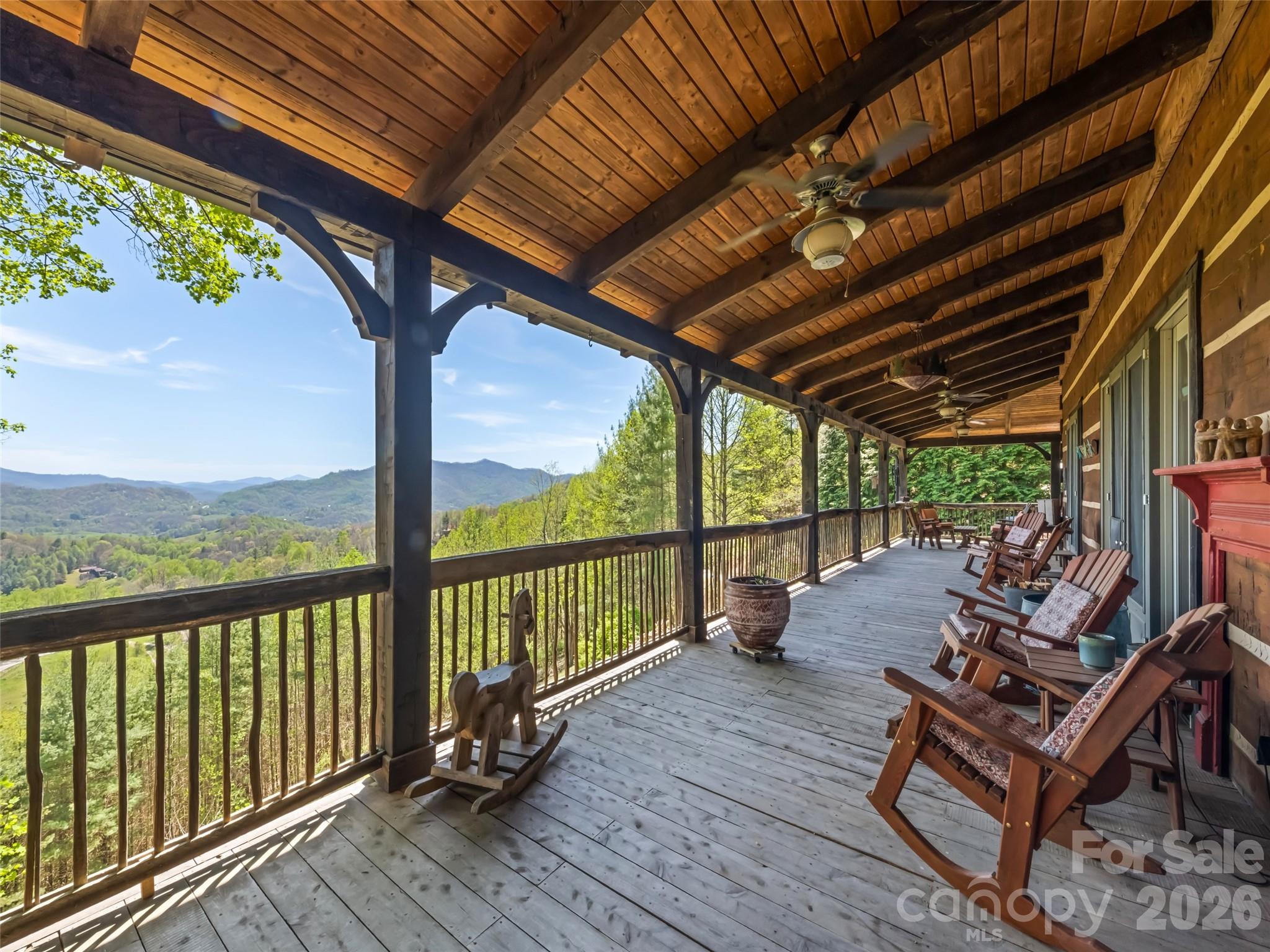 Is there a better way to start or end your day than with long-range mountain sunrises and sunsets?

Welcome to this custom lodge at 234 Historic Oak Trail, located in the Covel Creek area just outside of Waynesville, NC. Set on nearly 2.5 acres, this property offers a peaceful retreat less than 20 minutes from downtown Maggie Valley and Waynesville.

The home features modern finishes and a thoughtful floor plan. The main floor welcomes you with vaulted ceilings and expansive windows offering spectacular views toward Chambers Mountain, Asheville, and the Great Smoky Mountains National Park. The kitchen is equipped with a large island, custom painted cabinets, Spanish tile countertops, stainless steel appliances, and a Kohler farm sink. The adjacent dining area and generous family room—featuring a reclaimed Chicago brick fireplace with a live-edge mantle—provide the perfect setting for gatherings with sliding door access to the deck.

The main-floor primary suite includes large corner windows, private deck access, two walk-in closets, and a conveniently located laundry room. The primary bath is well-appointed with a double vanity, a soaking tub, and a specialized shower. Upstairs, you will find four additional rooms used as bedrooms, two bathrooms, and two versatile alcoves. The walk-out lower level includes another bedroom, a full bath, and a large recreation room.

Additional features include a whole-house generator and outdoor amenities such as a fire ring and wrapping wide decks. The property is frequently visited by local wildlife, and the included run-in barn and usable land offer the perfect opportunity to start a mini-farm.

Come home to 234 Historic Oak Trail today - Views are phenomenal and match the outstanding quality of the lodge.