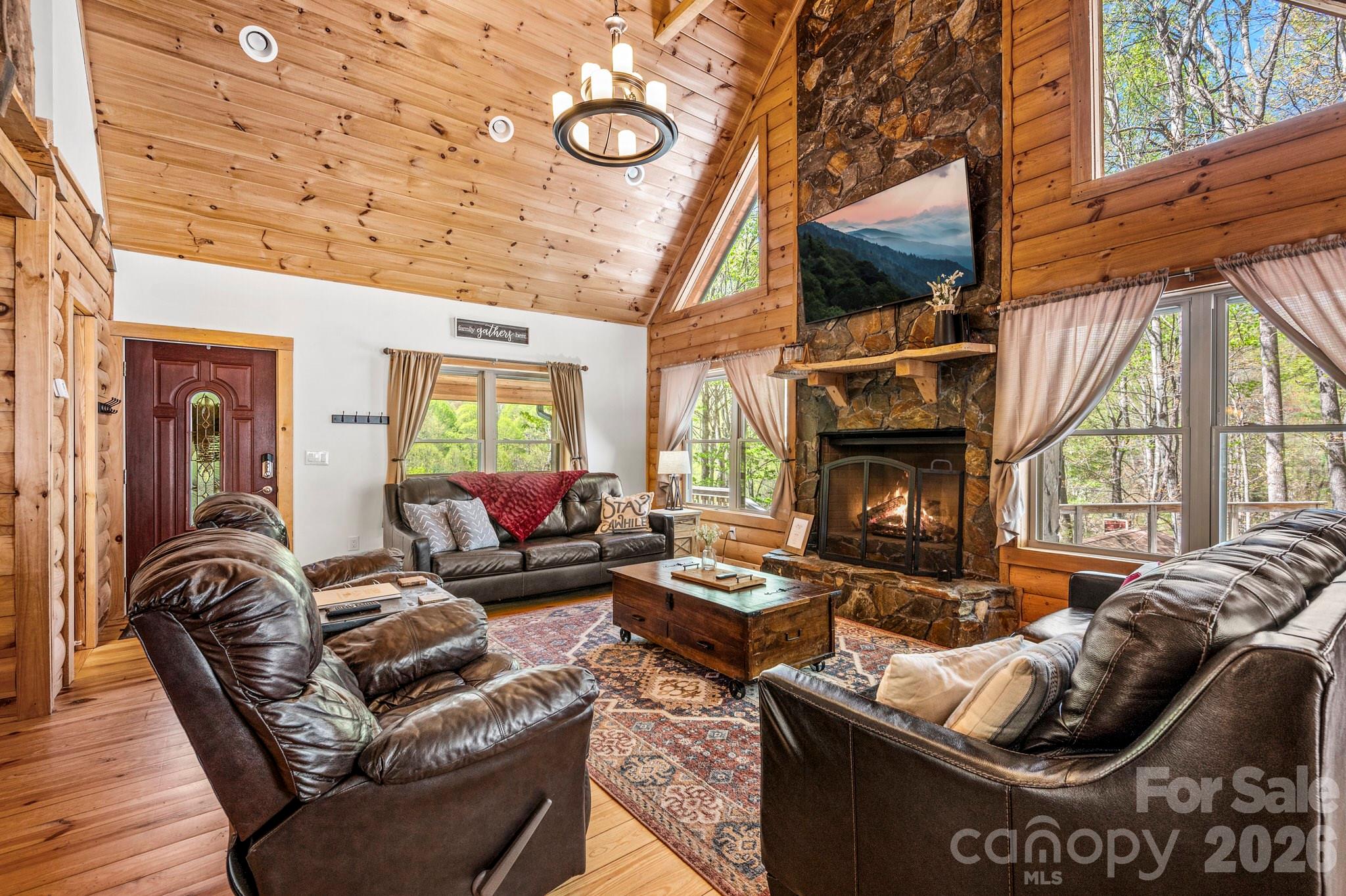 MOUNTAIN RETREAT – TURN-KEY CABIN / STR-OPTIMIZED / HOT TUB / OUTDOOR FIRE PIT / NO HOA/POA

Tucked just seconds off Fie Top Road in the heart of Maggie Valley, this fully-furnished mountain retreat offers the perfect blend of privacy, accessibility, and income potential. Located just below Cataloochee Ranch/Ski Resort & the Blue Ridge Mountains, this 3-bedroom, 3.5-bath cabin is designed for both lifestyle & short-term rental use.

Step inside to an inviting open-concept layout with soaring ceilings, abundant natural light, and a warm, rustic design anchored by a floor-to-ceiling propane fireplace, ideal for cozy mountain evenings. The spacious kitchen features granite countertops, stainless-steel appliances, propane stove/oven, and a functional breakfast bar, creating a seamless flow for entertaining guests or hosting family gatherings.

The home offers a thoughtfully-designed layout with a private upper-level primary suite, complete with its own private deck, while the lower level provides additional living space, perfect for guests, extended stays, or maximizing rental flexibility.

Outdoor living is where this property truly shines. Multiple decks, a private hot tub, & a custom fire pit area create a memorable guest experience surrounded by the natural beauty of the Smoky Mountains. Whether enjoying peaceful mornings or evenings under the stars, every space is designed for relaxation & connection.

PROPERTY FEATURES – COMFORT / ACCESSIBILITY / PERFORMANCE
• 3 Bedrooms | 3.5 Bathrooms
• Approx. 2,000+ SF w/finished lower level
• Built 2008 and Finalized in 2018 | ~0.52-acre private wooded lot
• Multiple decks + hot tub + fire pit area
• Strong Wi-Fi + cell service for remote work
• Paved access – no 4WD required
• Fully furnished and turnkey

Located just minutes from downtown Maggie Valley, with easy access to Waynesville, the Blue Ridge Parkway, and year-round outdoor recreation, this property is ideally positioned for both lifestyle buyers and investors seeking a proven mountain rental.

Whether you’re looking for a personal escape, a second home, or a investment/revenue-generating property, this cabin delivers on all fronts.
