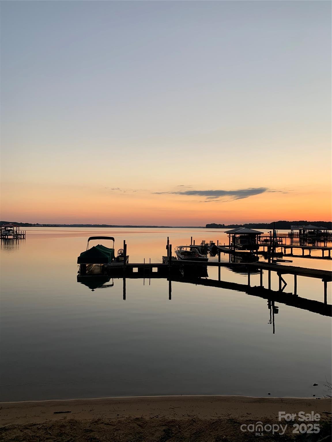 Rare find! Build your dream home or weekend retreat on this beautiful Lake Norman waterfront lot in desirable Denver, NC (Lincoln County). Conveniently located near Cowan's Ford Golf Club, this property offers the perfect balance of privacy and accessibility--tucked within a charming residential area just minutes from shopping, restaurants, major highways, Charlotte Douglas International Airport, and Uptown Charlotte. Enjoy breathtaking full channel views from your backyard, complete with a natural beach and boat pier/dock already in place. A well is installed, along with a septic system (size currently unknown), providing a head start for your future build. Whether you are seeking a serene weekend getaway or a year-round residence on Lake Norman, this lot delivers unmatched views, convenience, and waterfront lifestyle opportunities. Note: functional mobile home and utility shed on property at no value.