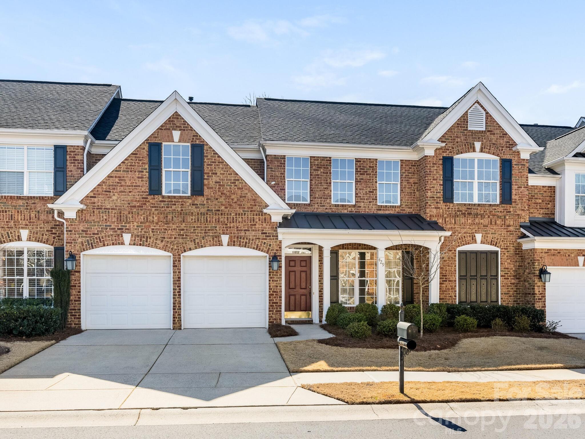Welcome to 429 Eberle Way, a beautifully maintained brick townhome offering timeless style and effortless living just minutes from charming downtown Matthews. Inside, you're greeted by a light-filled dining room featuring an elegant tray ceiling, classic wainscoting, and new Mohawk laminate wood flooring (installed 2026) that flows throughout the main level. The spacious living room impresses with vaulted ceilings and a cozy gas fireplace, creating the perfect gathering space. It opens seamlessly to the white kitchen, complete with ample cabinetry and new GE stainless-steel appliances (installed 2026). Off the kitchen, you will find a spacious laundry room. The main-level primary suite serves as a peaceful retreat, boasting tray ceilings and a generous en suite bath with double vanity, soaking tub, separate shower, private water closet, and a large walk-in closet. Upstairs, you’ll find two additional bedrooms, a versatile loft space perfect for a home office or play area, and a spacious full bath with double vanity and tub/shower combination. Enjoy outdoor living in the private, fenced-in patio and separate grass area — perfect for gardening or entertaining. A two-car attached garage and additional driveway parking. New HVAC units installed in 2025. This thoughtfully designed townhome combines comfort and functionality in a prime location just minutes from historic downtown Matthews and the scenic Four Mile Creek Greenway — a place you’ll truly love coming home to.