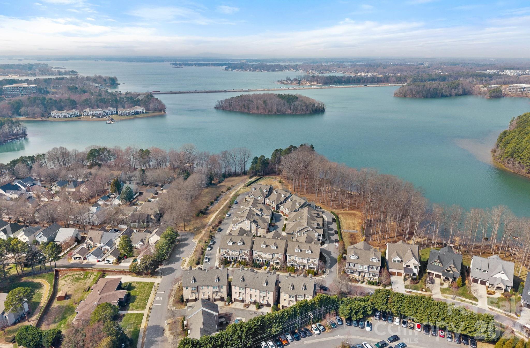 NEW PRICE! Priced lower than last sold home. Up to $2,500 in lender credits with OriginPoint. This luxurious 4 Bed, 4.5 Bath Townhome includes lots of sqft, upgrades and open spaces. All 3 stories are serviced by an Elevator providing easy access when needed. End Unit provides tons of natural light flow in the home and accentuates the soaring ceiling height. Main level welcomes you with a cozy Great room with gas log Fireplace, open to casual Dining and a Gourmet Kitchen. The Island is large enough for additional seating and storage. Abundant cabinetry and gourmet SS appliances, like the Italian Bertazzoni 5 Burner Gas Range and Hood. Pantry has double glass doors and custom shelving. Drop Zone and the 1/2 bath are by the 2 car attached Garage entry. Don't miss the garage storage and Epoxy floor. Entertaining friends and family easily flows from indoors to outdoors with the large sliding doors to the beautiful courtyard style terrace. Middle level has 2 guest Bedrooms each with Ensuite Baths featuring Quartz countertops and the Primary Bedroom located privately in the rear of the home. Primary includes built in shelving and a custom designed Closet. Spa Bathroom offers dual sinks and Quartz countertop, soaking tub and separate shower which will melt away all your stress. End the day on the Private Screened in Balcony. Laundry room is also on the middle level for ease of use. Top level is open to staircase so works well for a Studio/Office/Bonus although it can serve as a 4th Bedroom with another Ensuite Bath, Custom Closet and Storage. Extra bonus is the wet bar with sink, Bev fridge and microwave. Plantation shutters throughout. One of the most well known Lakefront communities in the Lake Norman area. Davidson Bay consists of a variety of townhomes and single family homes. 744 Amalfi is part of a prestigious 20 home grouping with private Lakefront access and dedicated kayak storage. Short distance to Downtown Davidson, local restaurants and grocery.