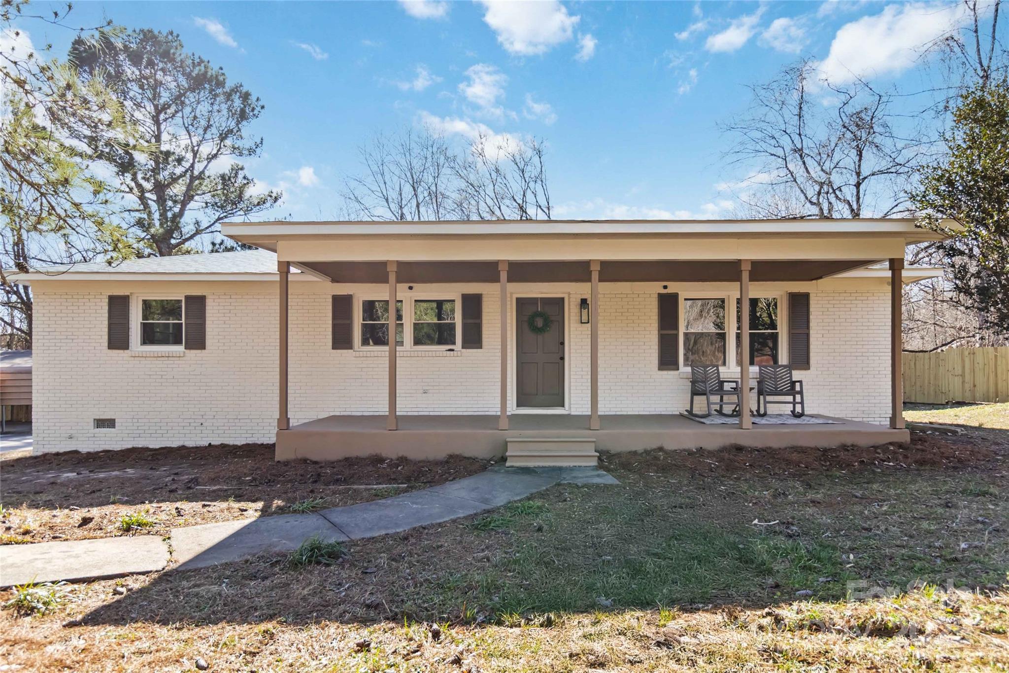 NEW PRICE $255,000! Country charm meets modern updates in this beautifully renovated 3BR, 1BA brick ranch on 1 acre in Sharon, SC. Don’t let the location fool you—only 30 mins to downtown Rock Hill and 10 mins to downtown York! Enjoy peace and privacy with a fully fenced backyard, new deck, and outdoor fireplace—perfect for evenings under the stars. Recent updates include new roof, HVAC, well pump, flooring, cabinets, and fixtures—move-in ready with plenty of storage and 3 carports for all your vehicles and gear. Inside, the spacious layout offers an open kitchen to living/dining plus a bonus flex space. All-electric, four-sided brick for easy maintenance. Tucked on a quiet street, yet close to shopping, dining, and everyday needs. Don’t miss this updated home at an unbeatable value!