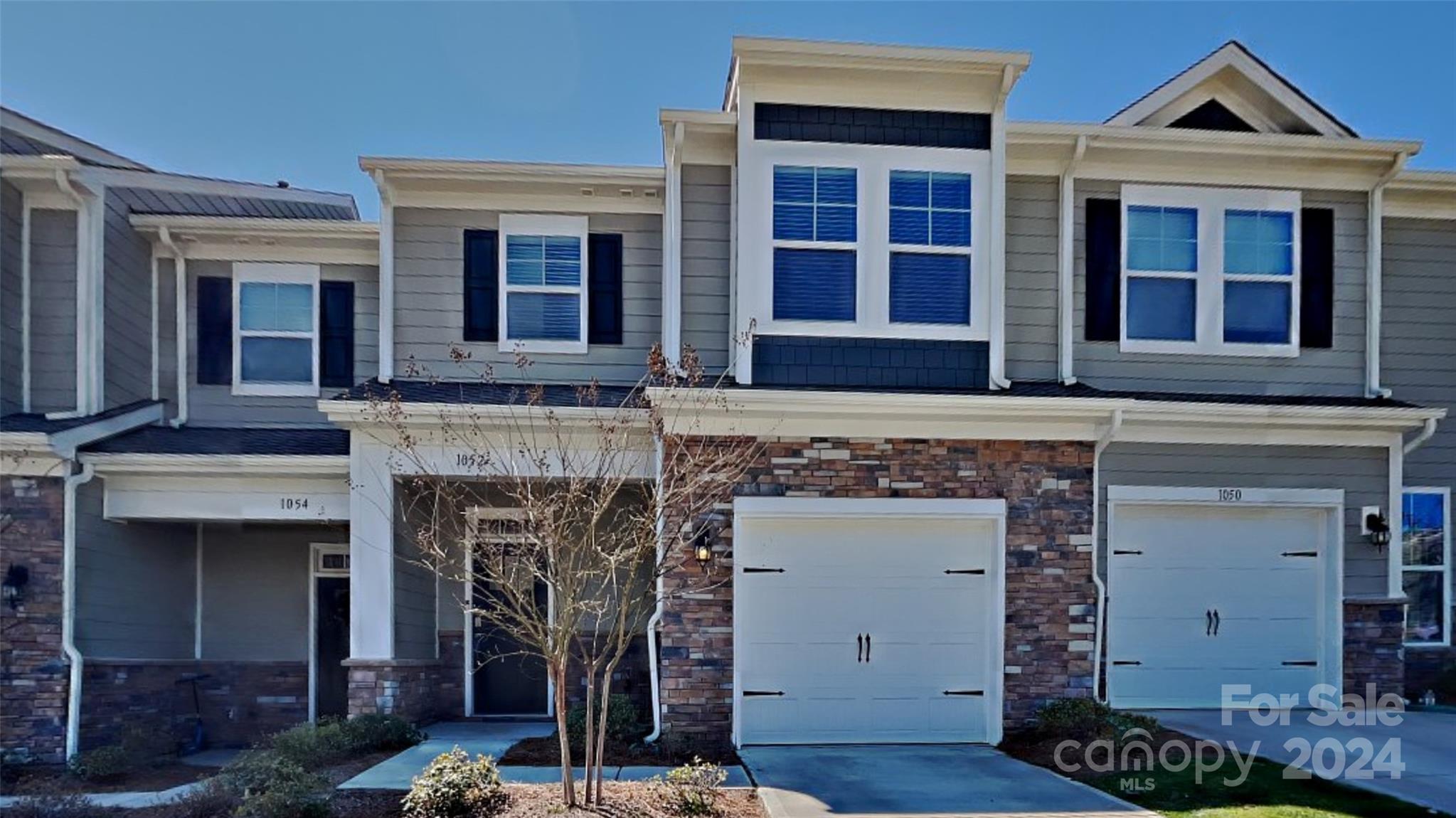Welcome Home! This beautiful, like-new townhome in the Lake Wylie area is fresh on the market and ready for someone to make themselves at home. The main floor is made up of a spacious, open-concept area, complete with living room, dining room, and kitchen with large center island. The kitchen features granite countertops and stainless appliances (range, microwave, and dishwasher to convey).Upstairs, there is a spacious laundry room with space for additional storage, as well as two spacious guest rooms, one with direct access to the full guest bath. Completing the upper level is a massive primary suite with attached bathroom, complete with large shower, dual sinks, and a massive walk-in closet. Stop by today, you won't want to miss this one!