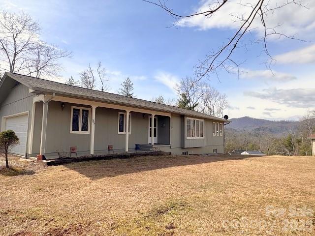 Must See Home ONLY 4 MILES from Blue Ridge Parkway entrance! Beautifully cared for home in Spruce Pine with year-round mountain views off the large rear deck! The home has a number of wood casement windows to enhance your view. You can access the deck from large sliding glass door in the cozy den OR through the Master Suite. Hardwood flooring on most of the main floor! NEW roof in 2025 / NEW fridge stays (1 month old). Outbuilding has electric.