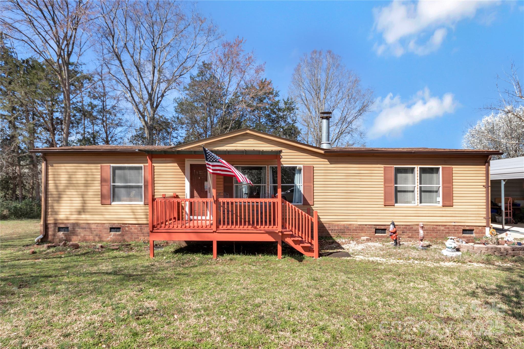 Welcome to this 3 bedroom, 2 full bath home that blends tranquility with convenience. Nestled in a country setting, but only minutes from Shopping, Dining and Interstates. This home is open, light-filled and features a spacious primary suite, private en-suite bath with a walk in shower and separate tub. The two additional bedrooms provide flexibility for guests, a home office, or a growing family. Enjoy outdoor living on nearly 1 acre with a 12x20 out building perfect for a workshop, hobby space or plenty of extra storage. There is an additional 180 square feet work shop attached to the carport for even more space!