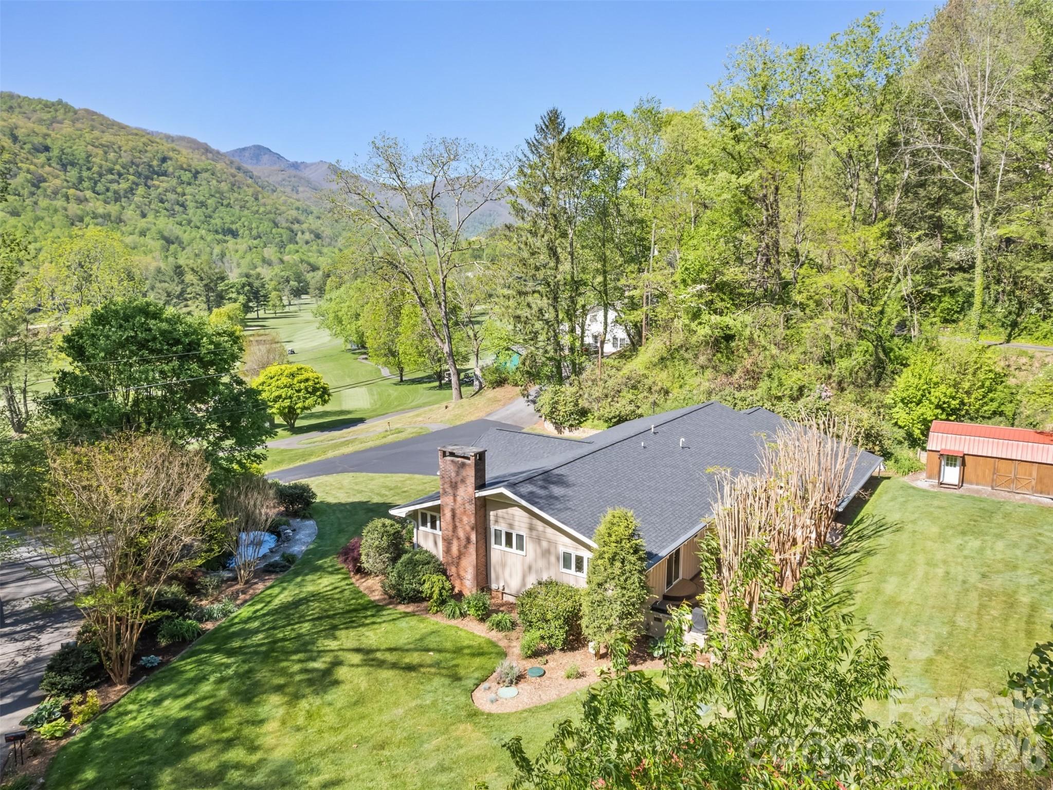 Enjoy stunning mountain views and an envious setting overlooking the front 9 holes of Maggie Valley Country Club Golf & Resort from this beautifully updated property designed for comfortable living, entertaining, and income potential. Located right on the 3rd tee with quick access to the course. FULLY updated and remodelled in 2016-2025. The main home features red oak hardwood and ceramic floors, and a spacious kitchen with quartz countertops, island, pantry, stainless appliances, gas stove. The vaulted ceiling great room includes a gas log fireplace, windows with impressive views, and recessed lighting, laundry room, 2nd bedroom, and BONUS room. The luxurious primary suite offers a spa-like retreat with a double granite vanity, heated towel rack, and a steam shower for two. Outdoor living shines with Trex decking, a screened porch, and an outdoor kitchen patio complete with grill and smoker—perfect for enjoying cool mountain breezes. **The separate 2ND LIVING QUARTERS (518 SqFt) apartment offers excellent flexibility with its own exterior entrance, large bedroom, full bath, living/dining area, and kitchenette with bar refrigerator, microwave, sink, and cabinetry—ideal for guests, extended family, or private living space. ***Adding even more value, a 3RD LIVING QUARTERS (392 Sq Ft) detached 2020 cottage includes 1 bedroom, 1 bath, full kitchen, laundry, and living/dining area, creating outstanding income potential. A shed/workshop including John Deere mower, a pond with waterfall, koi and goldfish, and freshly recoated driveway (2025) complete this rare multi-generational mountain retreat. 2025 roof, updated plumbing and electrical (2016), city water and sewer, a 2-car garage, and gas tankless water heater. Golf cart included (needs batteries).