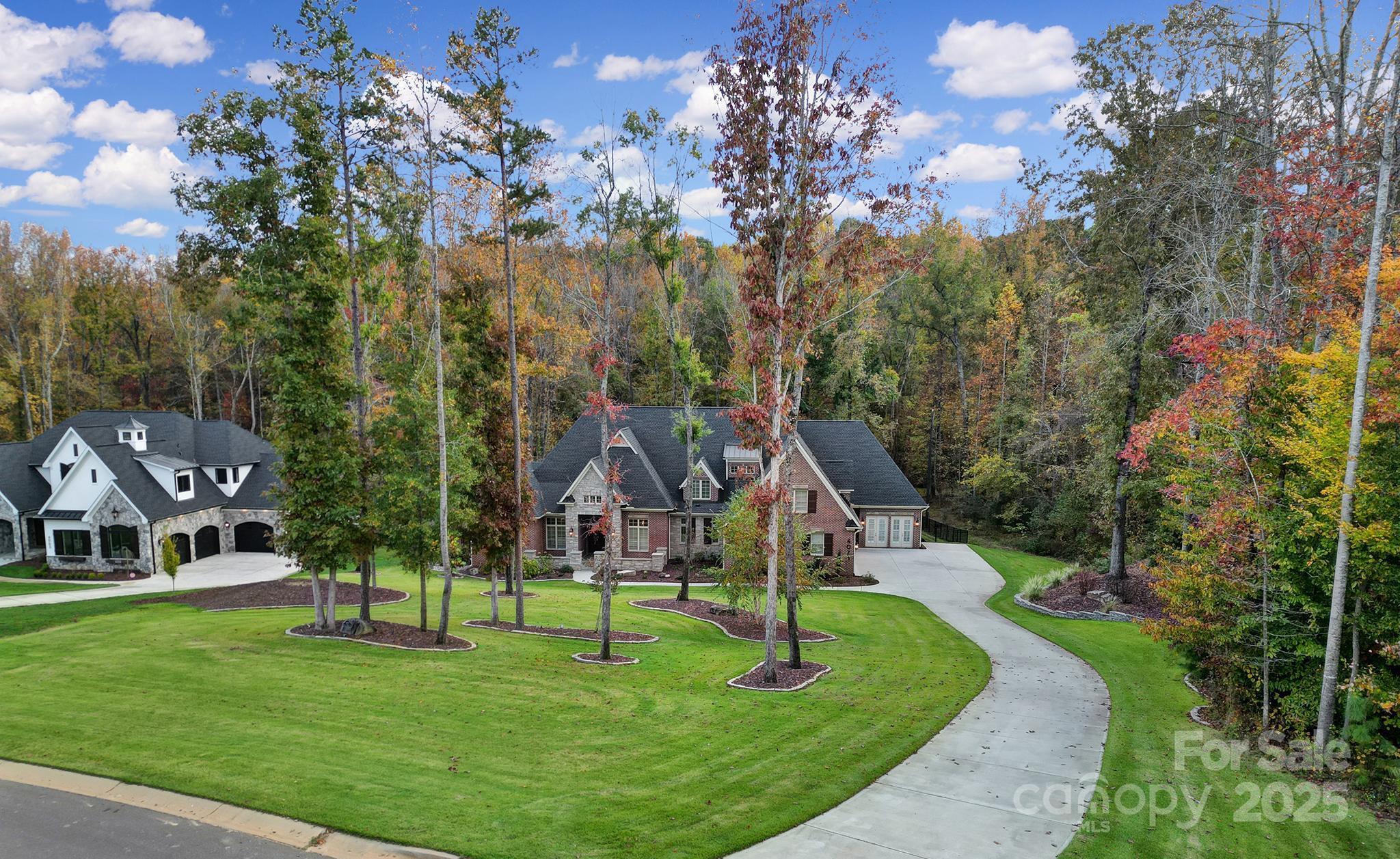 This enclave of luxury boasts estate homes residing on 1+ acre lots. This luxurious home features a grand foyer with soaring cathedral ceilings overlooking private outdoor living. Family room features impressive vaulted ceilings with beams, gas stone fireplace and French doors leading to a covered patio complete with gas stone fireplace. Volume ceilings continue as you enter the owners suite wing.  Spa-like bathroom with soaking tub and oversized walk-in closet. Main level generational ensuite includes private den. Gourmet kitchen w/ 11ft ceilings, Sub-Zero refrigeration, Wolf induction stovetop. Additional features: whole house generator, gym w/rubber floors (heated/cooled and can be converted into 4th garage), saltwater pool/spa with heater and chiller, stone fire pit w/gas starter, fully fenced, hardwood flooring throughout, plantation shutters, three-car garage, EV hookup, sealed crawlspace, foam insulation and ample storage space.