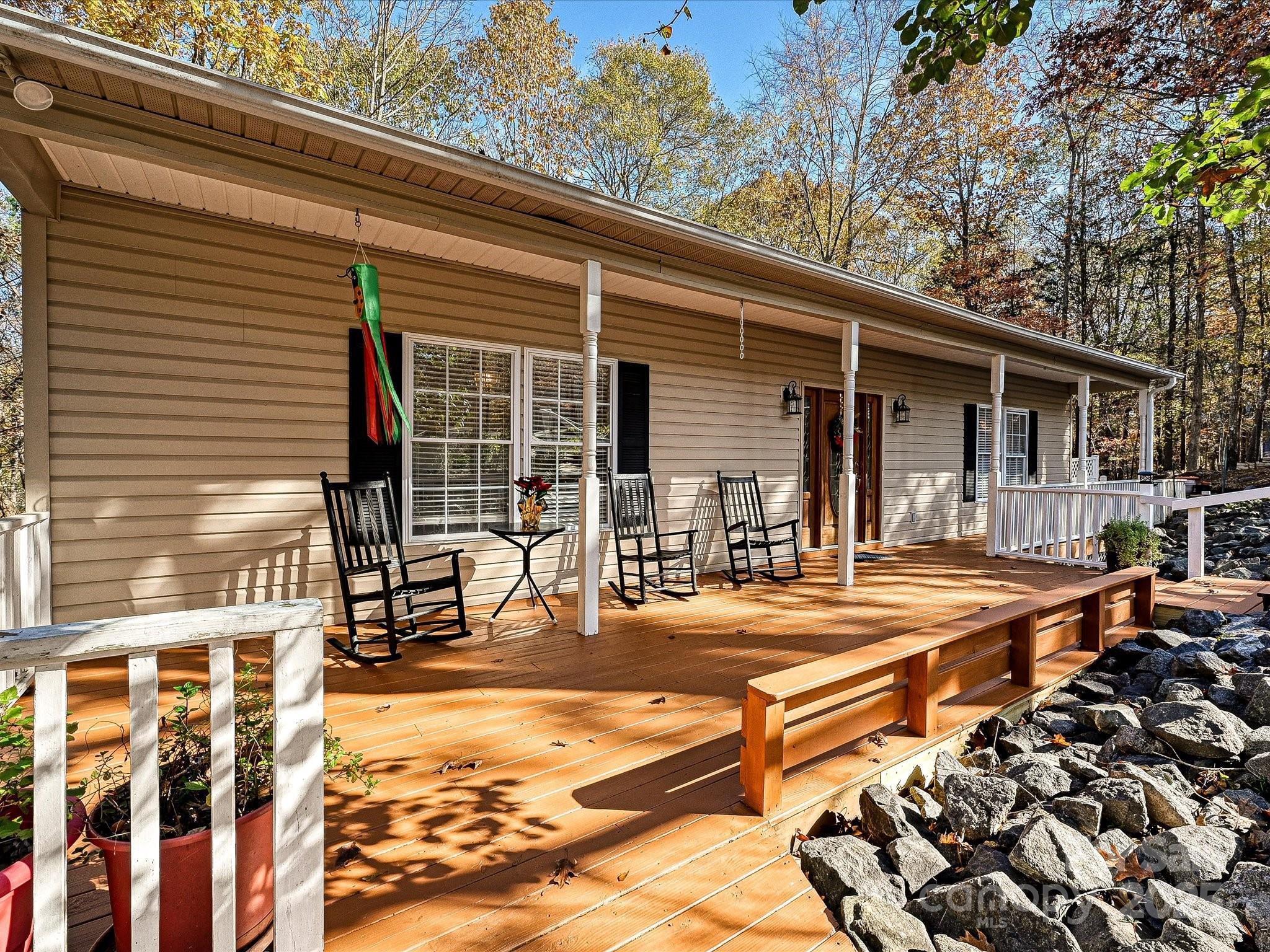 Enjoy this wonderful, waterfront community in fabulous Tega Cay with miles of trails, tennis, golf, pickleball, swim club, parks, & marina. Located on the peninsula with nearby lake access, this 3/4 acre, golf front lot gives the nature lover trees & privacy. Two level living on a double lot offers an open Great Room, Dining Area, & Kitchen with lots of cabinets, room for an island, and a deep stainless farmer's sink. All appliances remain. The Owner's Suite has a large walk in closet, separate shower, spa tub, and opens onto a screen porch. A Second Owner's Suite on the opposite side of the house opens out onto one of several decks. The lower/basement area would be perfect for long-term guests/au pair/teens/in-laws with the third Bedroom, Full Bath, another Great Room, and large storage room.  The downstairs area can be accessed from within the house or via separate entry. Both levels open onto screened porches and extensive decking for entertaining, solitude, and wildlife viewing.  An oversized 2 car basement garage has amble space for a workshop or lake toys. The cottage-like shed would be perfect for gardening or crafts plus there's a second shed for even more storage.  In addition to resort style amenities, social and service clubs, and the number one activity of golf carting, Tega Cay also offers Award winning schools, low SC taxes, and no HOA.  Live the good life in Tega Cay, the number one suburb in SC.