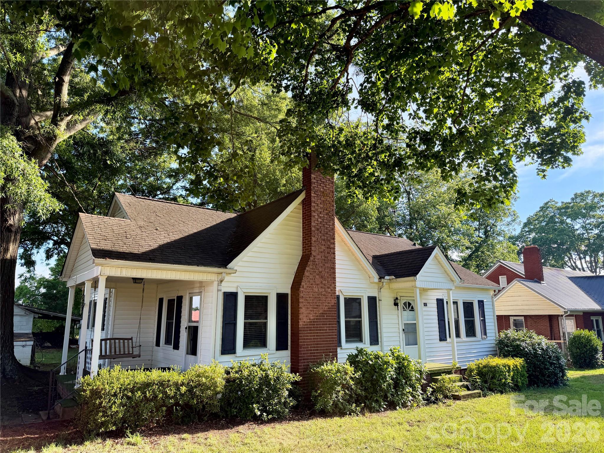 Professional pictures coming!! Imagine starting your mornings with a cup of coffee on the porch swing as the neighborhood wakes up around you, and ending your evenings gathered by the crackling wood-burning fireplace. This charming cottage-style home offers a relaxed, comfortable lifestyle with so much character and plenty of space to enjoy both indoors and out. Situated on a generous 1/3-acre lot, this home offers room to breathe while maintaining the warmth and charm that make cottage living so special. The expansive backyard with fencing is perfect for pets, gardening, outdoor games, and/or hosting family and friends. The enclosed back porch provides a peaceful retreat for reading, relaxing and enjoying the changing seasons year-round. Inside, beautiful hardwood floors flowing throughout the home and granite countertops blend timeless character with everyday convenience. Just minutes from Lake Norman, vibrant downtown Mooresville, popular restaurants, local boutiques, and everyday shopping, you'll enjoy the convenience of having everything you need close by while still coming home to a sweet retreat. This is a rare opportunity to experience small-town charm, outdoor recreation, and modern conveniences all in one desirable location. Whether you are entertaining guests, enjoying quiet moments at home or creating lasting memories with loved ones, this property is ready to welcome you.