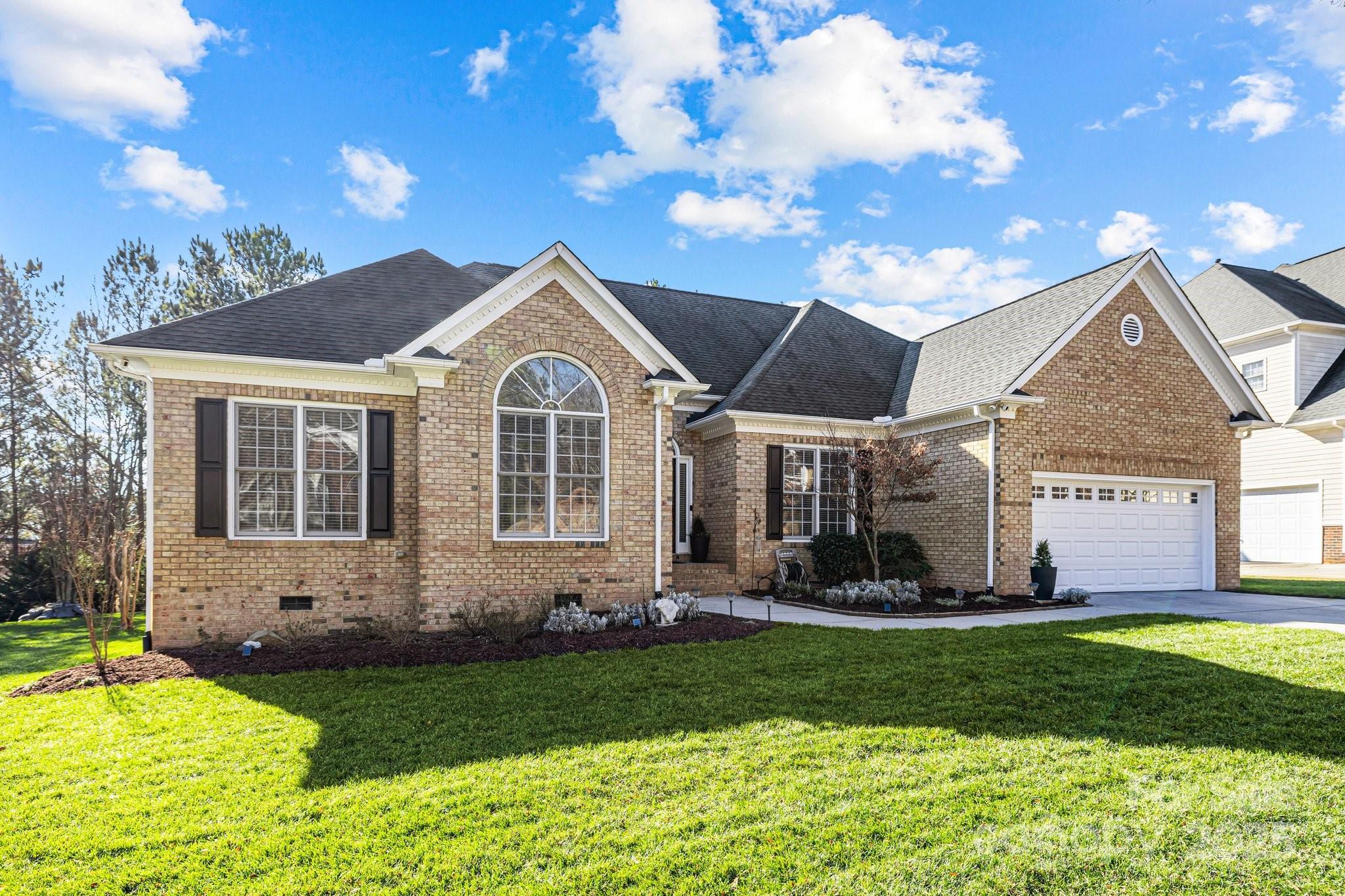 This is the one you have been waiting for! This brick front home backing up to woods, has it all!  With 5BR/3BA and a bonus room, this home features updated BRs with gorgeous tile floors and tile surrounds in the showers, quartz or granite counters, tasteful vanities and neutral paint throughout. In addition, the remodeled kitchen features elegant white cabinets, SS appliances, granite counters, new DW, a gas cooktop and brand new built in oven. Refinished HW floors in a natural stain are throughout the majority of the first floor. Plus new carpet was installed in the 4 of the BRs and bonus in 2024. In the great rm enjoy a stone fireplace, vaulted ceiling and access to the cozy screened in porch. Plus a fenced, flat backyard, a back deck, walk in storage that goes the length of the home, lawn irrigation, all new plumbing in 2024, new sewer line in 2023, new garage door in 2022, new irrigation controller in 2023, new HVAC in 2016. Amazing Tega Cay amenities and Fort Mill Schools!