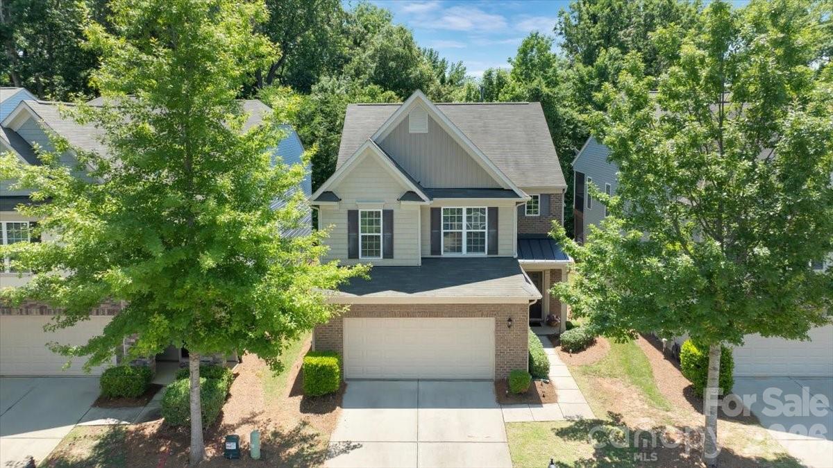 Welcome to one of Charlotte's most sought-after gated communities, offering low-maintenance living, resort-style amenities, and an unbeatable South Charlotte location. Just steps from the Little Sugar Creek Greenway, this beautifully maintained residence backs to a lush tree buffer with abundant natural light, creating a private retreat rarely found this close to the city's best dining, shopping, entertainment, and recreation. This home offers the perfect balance of convenience, connection, and comfort within a vibrant community atmosphere.

Inside, you're greeted by soaring ceilings and warm hardwood floors that create a welcoming feel from day one. Designed for everyday living and entertaining, the open-concept floor plan features a spacious living room anchored by a cozy gas log fireplace, generous dining area, large granite kitchen island with additional seating, and walk-in pantry. The finished two-car garage adds convenience and storage space for bikes, outdoor equipment, and more. The screened, covered rear porch overlooking the gated backyard is the cherry on top, creating the perfect space to entertain, enjoy morning coffee, or simply take in the serene greenway backdrop.

The thoughtfully designed layout offers 3 spacious bedrooms, 2.5 baths, and a versatile loft ideal for a home office, media space, workout area, hobby room, or flex space. The primary suite features a stunning tray ceiling, private views of the mature tree-lined backyard, and a generously sized walk-in closet with custom built-ins. Secondary bedrooms provide ample room and closet space, while the upstairs laundry room adds everyday convenience.

Residents enjoy stress-free exterior maintenance and lawn care, along with exceptional amenities including an Olympic-sized pool, fully equipped gym, deluxe playground, dog park, clubhouse, gathering spaces, weekly food trucks, and seasonal events. Google Fiber is already in place, making remote work, streaming, and staying connected easier than ever.

When it's time to explore, you're minutes from SouthPark shopping, South End's restaurants, breweries, the Charlotte Regional Farmers Market, Uptown museums, Blumenthal Performing Arts Center, Ballantyne shopping, the much anticipated Wegmans Grocery, and Charlotte Douglas International Airport. Outdoor enthusiasts will appreciate direct access to the Little Sugar Creek Greenway, connecting residents to miles of walking, running, and biking trails, parks, playgrounds, tennis and pickleball courts, and many of Charlotte's most beloved destinations.

Combining convenience, privacy, walkability, greenway access, resort-style amenities, and one of Charlotte's most desirable locations, 5122 Mount Clare Lane offers the lifestyle you've been searching for.