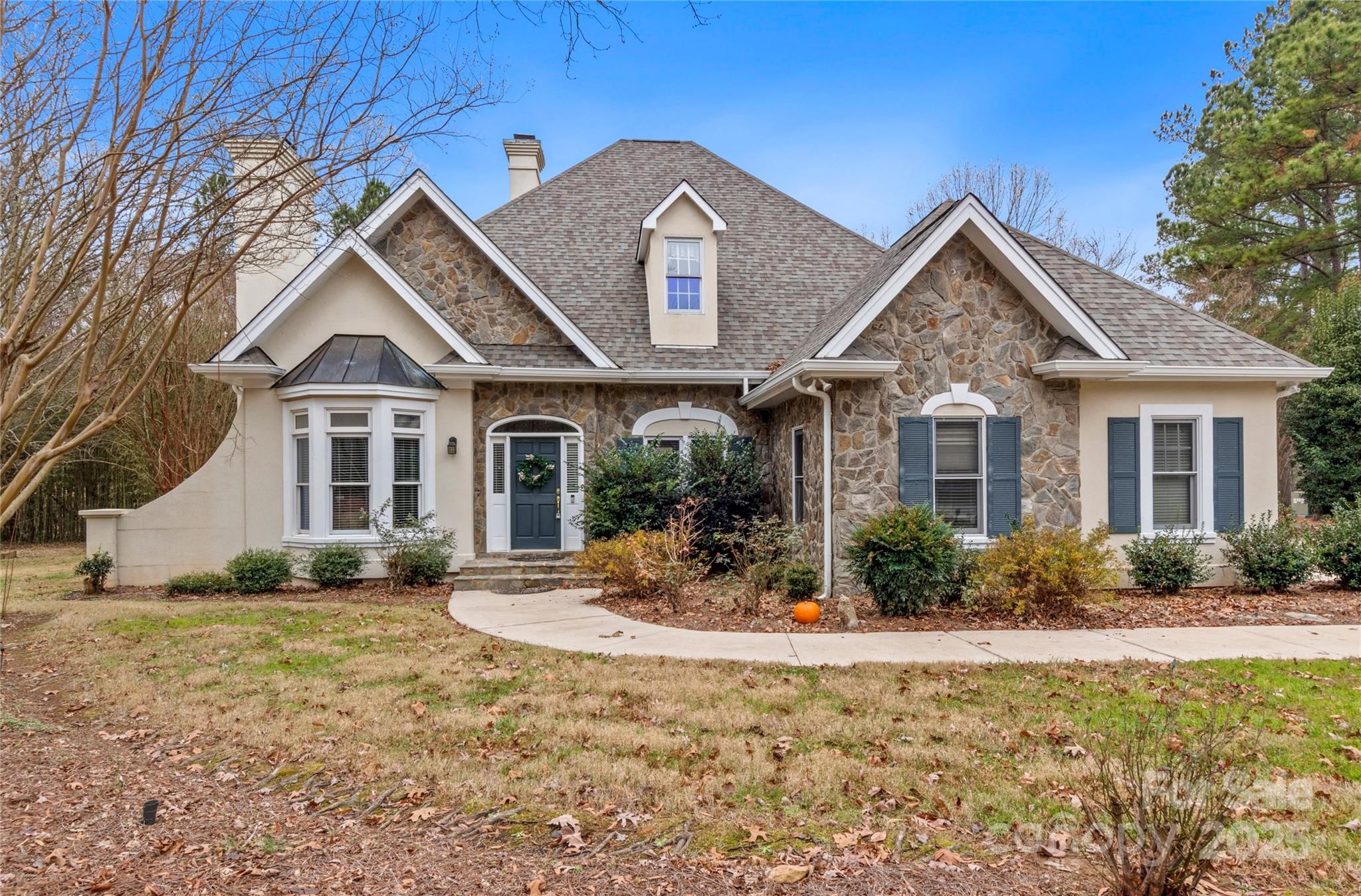 This well-maintained cottage-style home, situated within a gated community, offers the convenience of single-level living with picturesque views of the golf course. The property boasts a private lot, with no neighbors on either side, ensuring tranquility and seclusion. Inside, the open floor plan features a spacious living room, a den equipped with a gas fireplace, and a kitchen adorned with solid surface countertops. The primary suite includes a generous walk-in closet and an expansive bathroom. Additionally, a covered rear porch provides a serene view of the private backyard. The home also includes a two-car garage, and there is the option to purchase a membership to the Old North State Club, granting access to a variety of country club amenities.