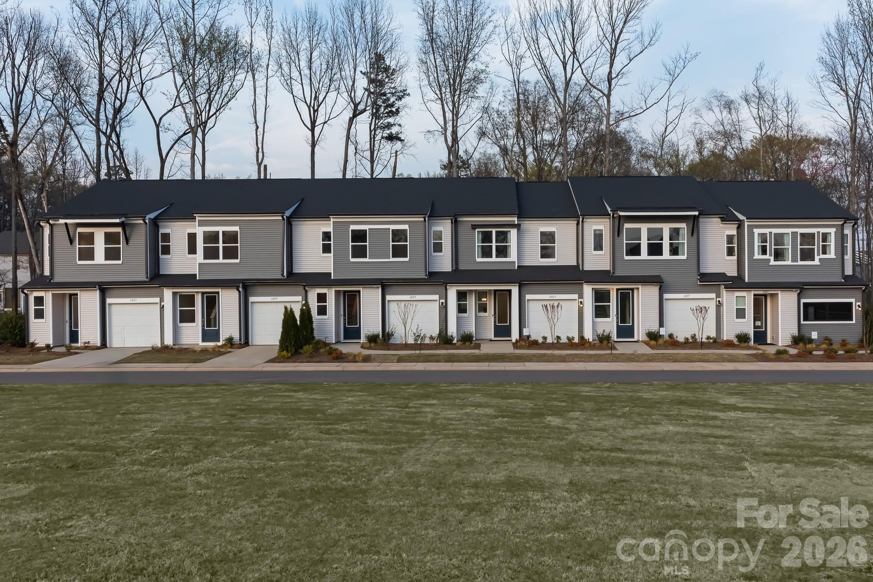 Welcome home to 6029 Longar Lane, an Hanover plan in Fifteen 15 Cannon. This model home comes complete with furniture and appliances included, so you can move right in and start living. Inside, an open concept floorplan on the first floor connects your living, dining, and kitchen spaces, where rich grey cabinets bring a sleek, modern feel. A dedicated dog area under the stairs gives your pup a spot to call their own. Upstairs, you'll find 3 bedrooms and 2.5 bathrooms across 1,626 square feet, including a primary suite with a tiled walk-in shower. Step outside to your private outdoor living space with tree-line views, or head across to the open community space just steps from your door. A 1 bay garage completes the home. Enjoy sunlight-filled, low-maintenance living in a community with cared-for landscaping, tree-lined paths perfect for strolling with your dog, and Charlotte's energy, from dining to arts to entertainment, just moments away.