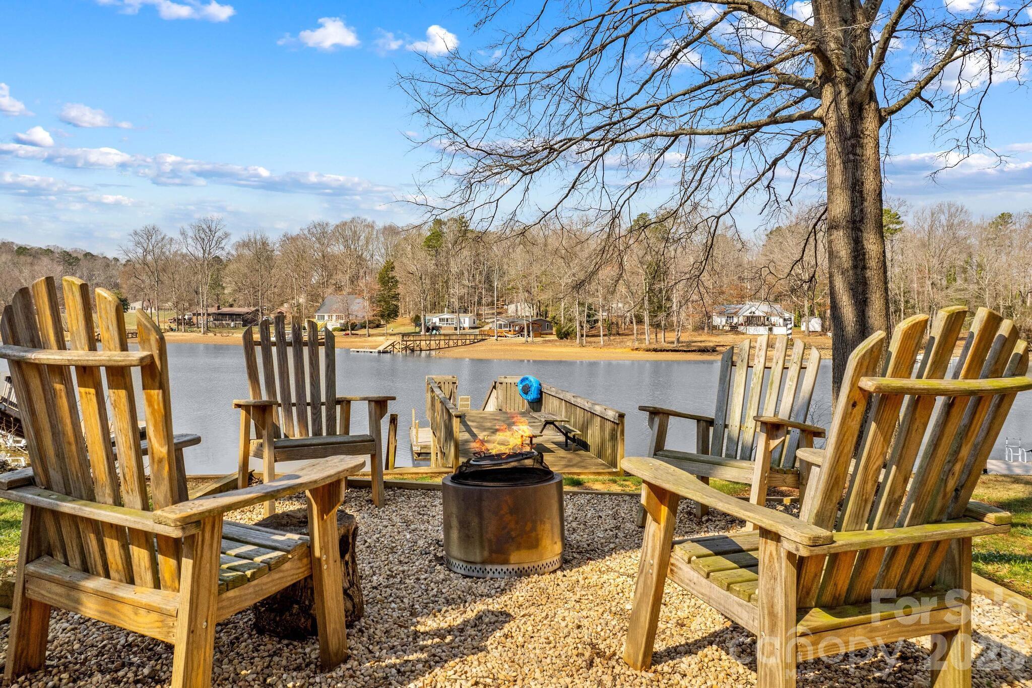 Beautiful Lakefront Property with Scenic Views of High Rock Lake and Investment Potential!! 

Enjoy the best of lake living in this spacious home offering over 2,000 heated square feet plus 266 additional unheated square feet, creating the perfect setting for entertaining and relaxing by the water.

This home features 3 bedrooms and 2 full baths with flexible living options. The main level showcases an expansive kitchen and dining area with abundant cabinetry and beautiful granite and butcher block countertops, making it ideal for gatherings. One bedroom and a full bath are also located on the main level. Don’t miss the charming loft area—perfect for an office or reading nook—with a stunning view of the lake (loft not included in square footage).

The lower level is designed for both comfort and entertainment, featuring floor-to-ceiling windows that capture breathtaking lake views throughout the day. This level offers two additional bedrooms, a full bath, a wet bar area, laundry space, and extra storage for all your lake toys.

Step outside to enjoy a 369 sq ft deck overlooking the fire pit area and your private floating dock/pier, providing easy access to the water. The front porch with screened-in area offers another peaceful spot to relax and take in the surroundings.

With beautiful views, ample space, and thoughtful features throughout, this home delivers comfort, charm, and the ultimate lake lifestyle.