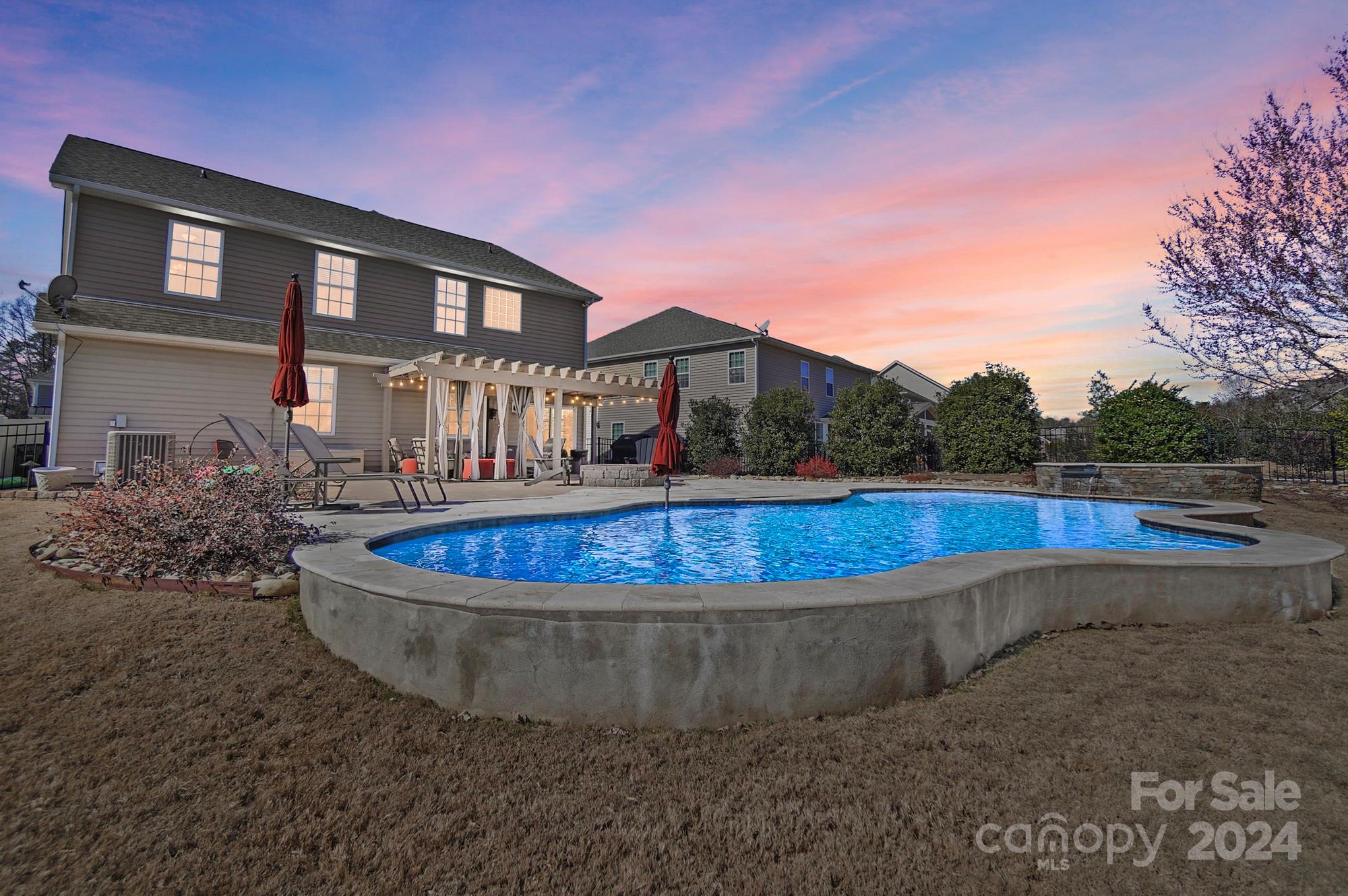 Showings start SATURDAY 2/10 for this move-in ready home minutes from shopping, dining & 77.  Entertain your friends & family with your own heated gunite pool-6 person hot tub with waterfall feature.  The eat-in kitchen leads out to the covered paver patio with fire pit and has lots of granite counter tops, cabinet space, stainless appliances, tile back splash, recessed & under cabinet lighting. The spacious primary suite has a dressing room like walk-in closet, en suite bath with separate water closet, linen closet & garden tub and shower with tile surround.  Our favorite features include, landscape lighting, custom drop zone with bench, main floor bed & full bath, full yard irrigation, fenced backyard, huge laundry room, iron stair railing, molding, archways, dining room tray ceiling, epoxy garage floor, extra storage in the garage under the stairs, hanging, and wall.  Carpet & paint updated in 2024.  HVAC updated 2020. Kitchen Refrigerator & 1 year warranty with acceptable offer.
