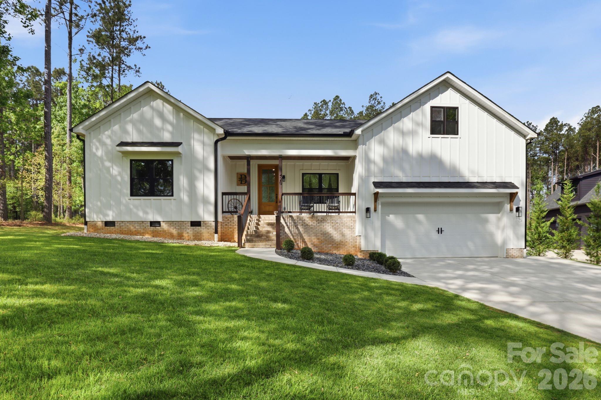Welcome to this stunning, modern farmhouse-style 1.5-story home where charm, space, and serene water views come together beautifully. Nestled on over an acre, this thoughtfully designed 4-bedroom, 3.5-bath home offers the perfect blend of modern comfort and timeless appeal.
Enjoy your morning coffee on the covered front porch with peaceful water views, or unwind in tranquil settings on the covered back deck. Inside, this spacious home features an open-concept floor plan ideal for both everyday living and entertaining. The inviting living area showcases an electric fireplace, while the kitchen is sure to impress with a large island, quartz countertops, a brick backsplash, soft-close cabinetry, abundant cabinet space, and a well-appointed scullery for added prep space and storage.
The main-level primary suite is a true retreat, offering a generously sized bedroom, a spa like bathroom, and direct access to the covered back deck perfect for relaxing in privacy. Also on the main level are two secondary bedrooms with a shared full bathroom, ideal for family or guests. Upstairs, you’ll find a private guest bedroom complete with its own full bathroom and walk-in attic storage perfect for visitors, or additional flex space. Every bedroom in the home features a walk-in closet, providing ample storage and functionality throughout.
The home features durable luxury laminate flooring throughout the main living areas and beautifully tiled bathrooms, combining style with low-maintenance living.
Water views can also be enjoyed from the front bedroom, adding to the home’s charm. Located just minutes from the state park, this property offers the ideal blend of privacy and convenience. A 2-car garage, potential for car lift with the soaring 15ft ceiling and expansive lot provide ample room for storage, outdoor living, and future possibilities.
If you’ve been searching for a beautifully maintained, one-owner farmhouse-style home with space, style, and scenic views—this one checks all the boxes.