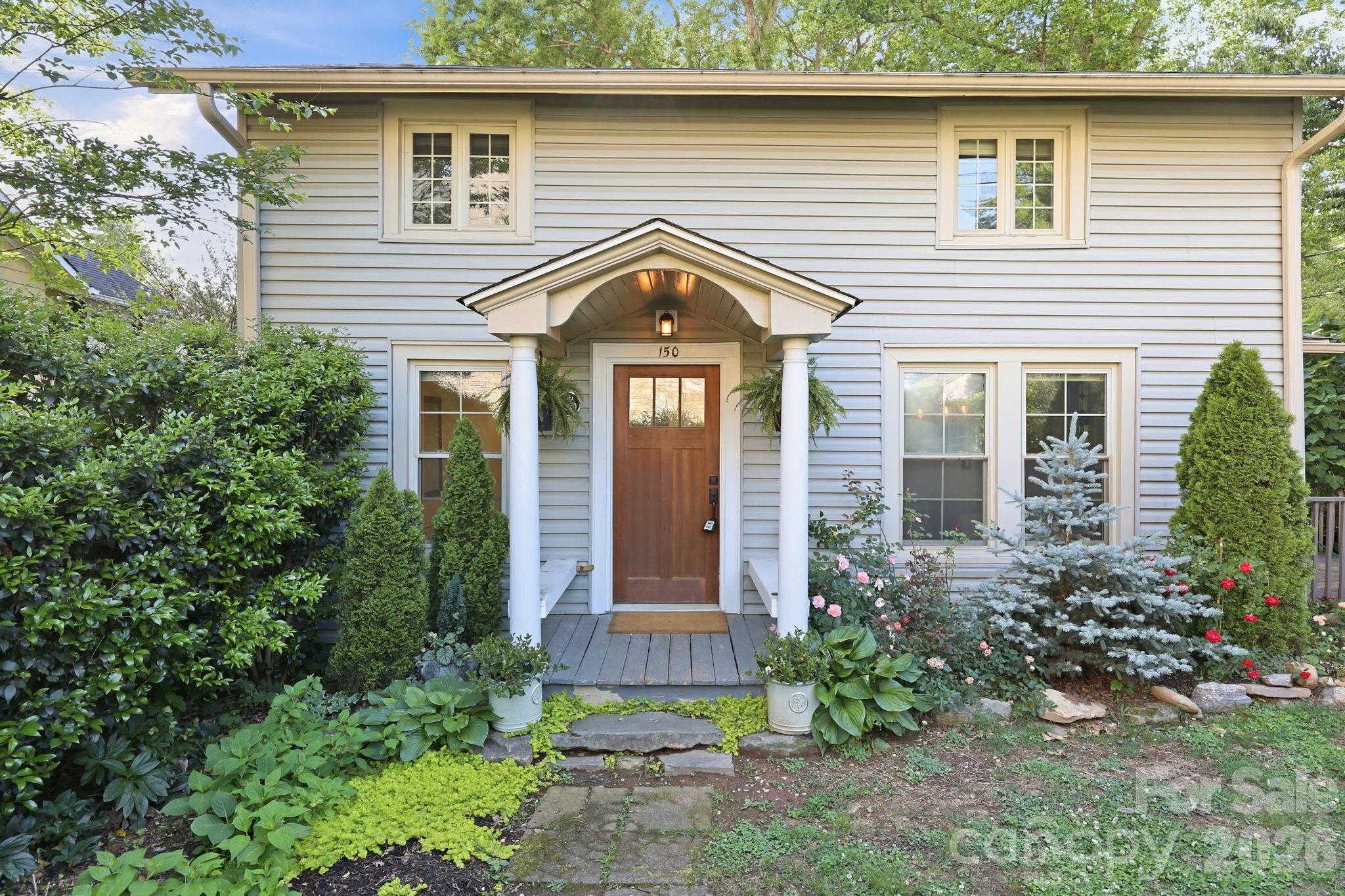 Downtown Bungalow! Location, location, location! Nestled in the heart of Tryon, this charming bungalow offers a private setting surrounded by roses and flowering trees. The main level features a living room with beautiful built-ins and a fireplace, an updated kitchen, dining area, and half bath with washer and dryer. An expansive wrap-around deck provides additional outdoor living space with room to relax or entertain. Upstairs, the primary bedroom includes a walk-in closet, while the second bedroom can be used for guests, an office, or flexible living space. A full bathroom and 3/4 bathroom completes the upper floor. Plus, there is a mini-split for extra cooling upstairs. Conveniently situated near local shops, restaurants, and entertainment, this property is well-suited for full-time living or a mountain getaway. Modernized old world, elegant charm this house lives much larger than it's square footage. Don't wait. Schedule your private tour today!