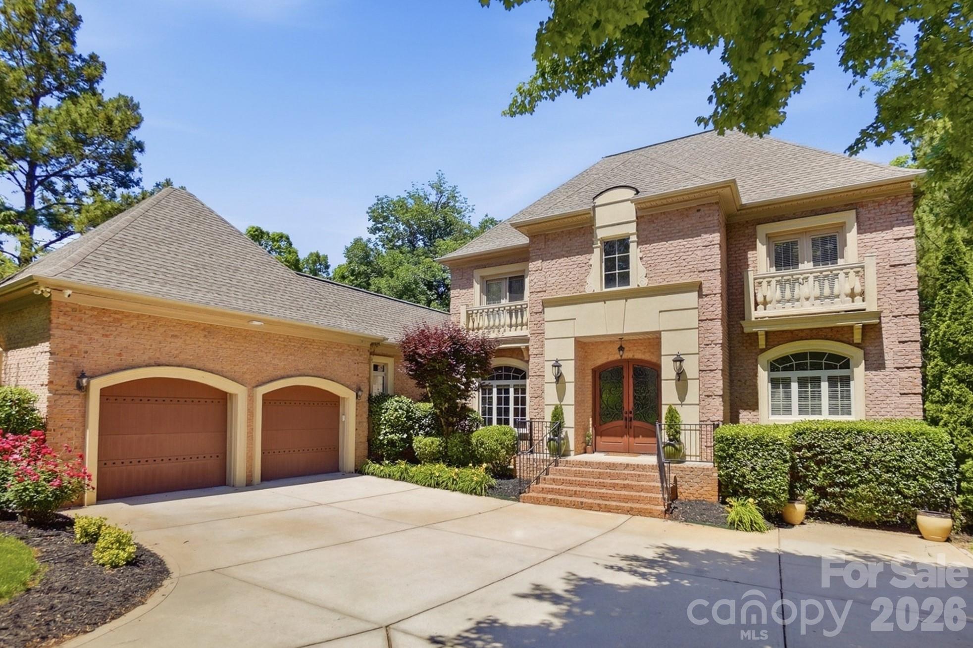Experience exceptional lakeside living in this stunning 6-bedroom waterfront estate with breathtaking views of Mill Creek Inlet on Lake Wylie. Designed for both luxurious everyday living and unforgettable entertaining, this showplace home offers incredible indoor and outdoor spaces, including a spacious terrace, covered patio, paver patio, lakeside deck, and covered floating dock with boat lift. Step inside to a grand foyer featuring a dramatic curved staircase, arched doorways, and elegant tile flooring. The open and inviting formal dining room with wet bar is perfect for hosting guests, while the impressive living room showcases a coffered ceiling, gas fireplace, and panoramic lake views. The gourmet chef’s kitchen is beautifully appointed with stainless steel appliances, gas cooktop, spacious center island, and opens seamlessly to a cozy great room with a striking stone fireplace. The luxurious main-level owner’s suite is a private retreat complete with a sitting area, fireplace, spa like bath, and glorious views overlooking the water. Upstairs, you’ll find four spacious bedrooms and ample storage. While the lower level offers a spacious family room with fireplace, rec room, flex room, massive executive office, and private guest suite. Enjoy resort-style community amenities in "The Landing" including a pool and clubhouse, all in a prime location with South Carolina taxes and award-winning Clover Schools.