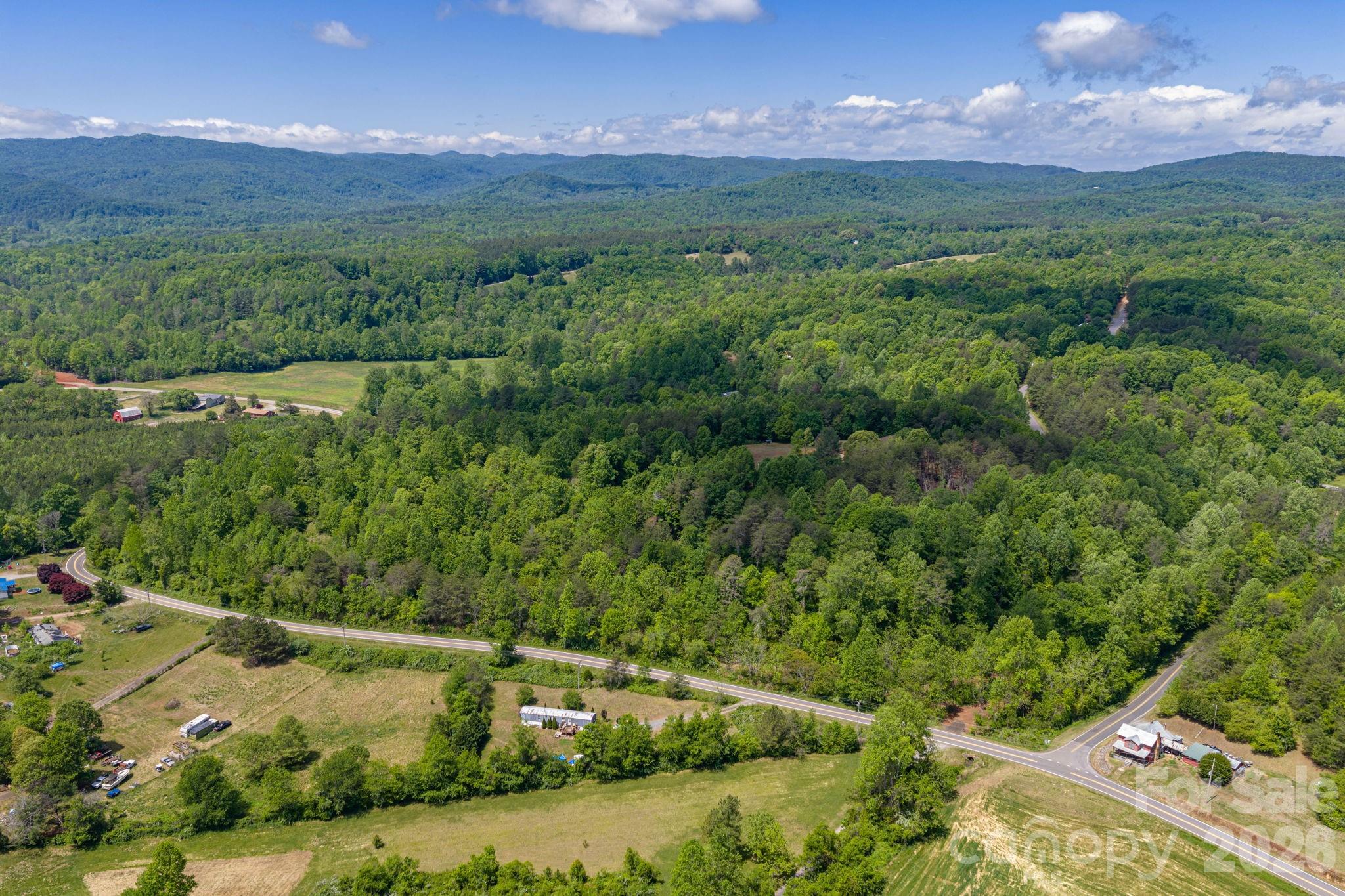 Here's your chance to own your own mountain getaway.  Build your custom home or set up a manufactured home on 6.19 acres.  Acreage has over 930' of road frontage and walking distance to Jacob Fork River.  County water is available.  Tap fee is required.  Start of the driveway is in place.