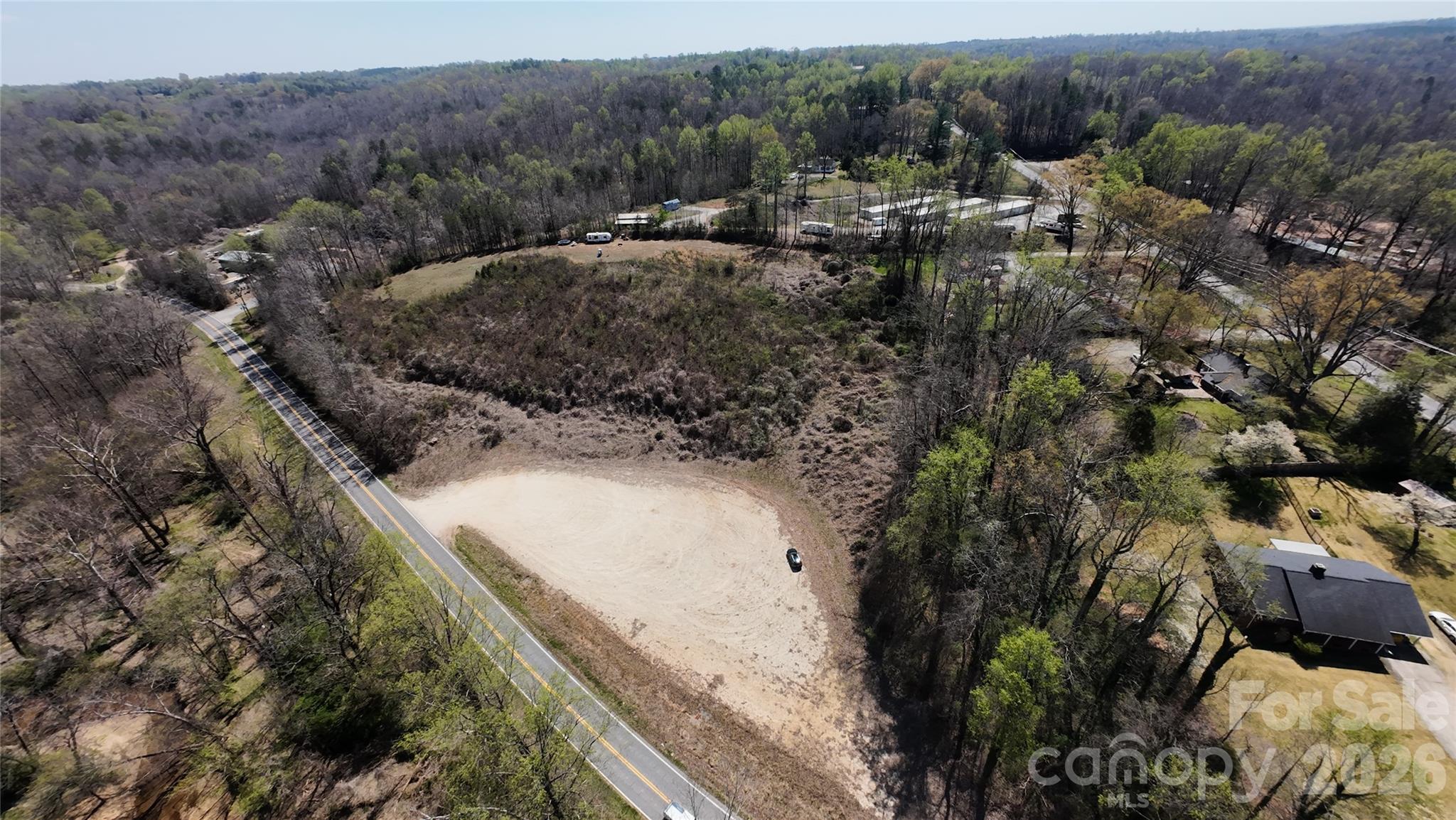 This 2.95 acre parcel, situated at the intersection of US 221 and Thunder Road, offers a unique opportunity for either residential or commercial use. The property features a graded pad already in place, making it ideal for immediate development. With its great location near a major corridor, this property provides easy access to surrounding communities like Forest City, Spindale and Rutherfordton. Public water is available along nearby US 221 but could require an easement across private property or a well could be installed.