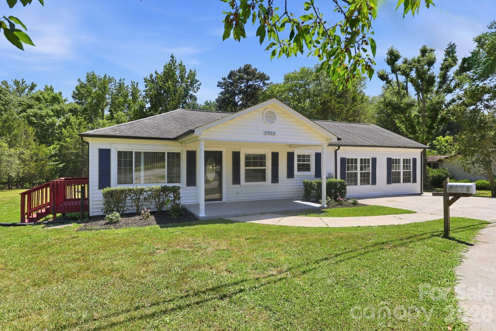 INCREDIBLE LIVE-WORK OPPORTUNITY! PRIME LOCATION JUST ½ MILE FROM I-85 WITH NO HOA! This beautifully renovated ranch home offers the rare combination of residential comfort and commercial potential, thanks to its Office/Limited Commercial (O-LC) zoning with residential use permitted. Whether you're looking for a spacious home, a home-based business location, professional office space, or an investment opportunity, this property delivers exceptional flexibility and value. Situated on a generous lot with the adjacent lot to the left INCLUDED, this property features an oversized & half-moon driveway with abundant parking—ideal for residents, clients, employees, or visitors. No HOA means no parking restrictions and endless possibilities. Inside, you'll find a completely updated and move-in-ready home featuring 4 bedrooms and 2 full baths, new luxury vinyl plank flooring throughout, new kitchen cabinets, stunning quartz countertops, new appliances, updated fixtures, and a new 4-bedroom permitted septic system. The spacious and open floor plan is designed for modern living and entertaining, offering a large living room with a contemporary electric fireplace, abundant natural light, and a sliding glass door leading to a side deck. The open-concept dining area, kitchen, breakfast area, and family room create an inviting atmosphere perfect for both residential and professional use. The primary suite features a walk-in closet and private sliding glass door access to the expansive rear patio overlooking the large, flat, and private backyard. Outdoor amenities include a welcoming covered front porch, two decks, and two storage sheds, providing ample space for recreation, storage, equipment, or business-related needs. With outstanding visibility, easy interstate access, flexible zoning, abundant parking, and a beautifully updated interior, this property presents a truly unique opportunity to live, work, invest, or grow your business—all in one location. Properties with this combination of location, flexibility, parking, acreage, and zoning are exceptionally hard to find. Schedule your showing today before this one is gone!