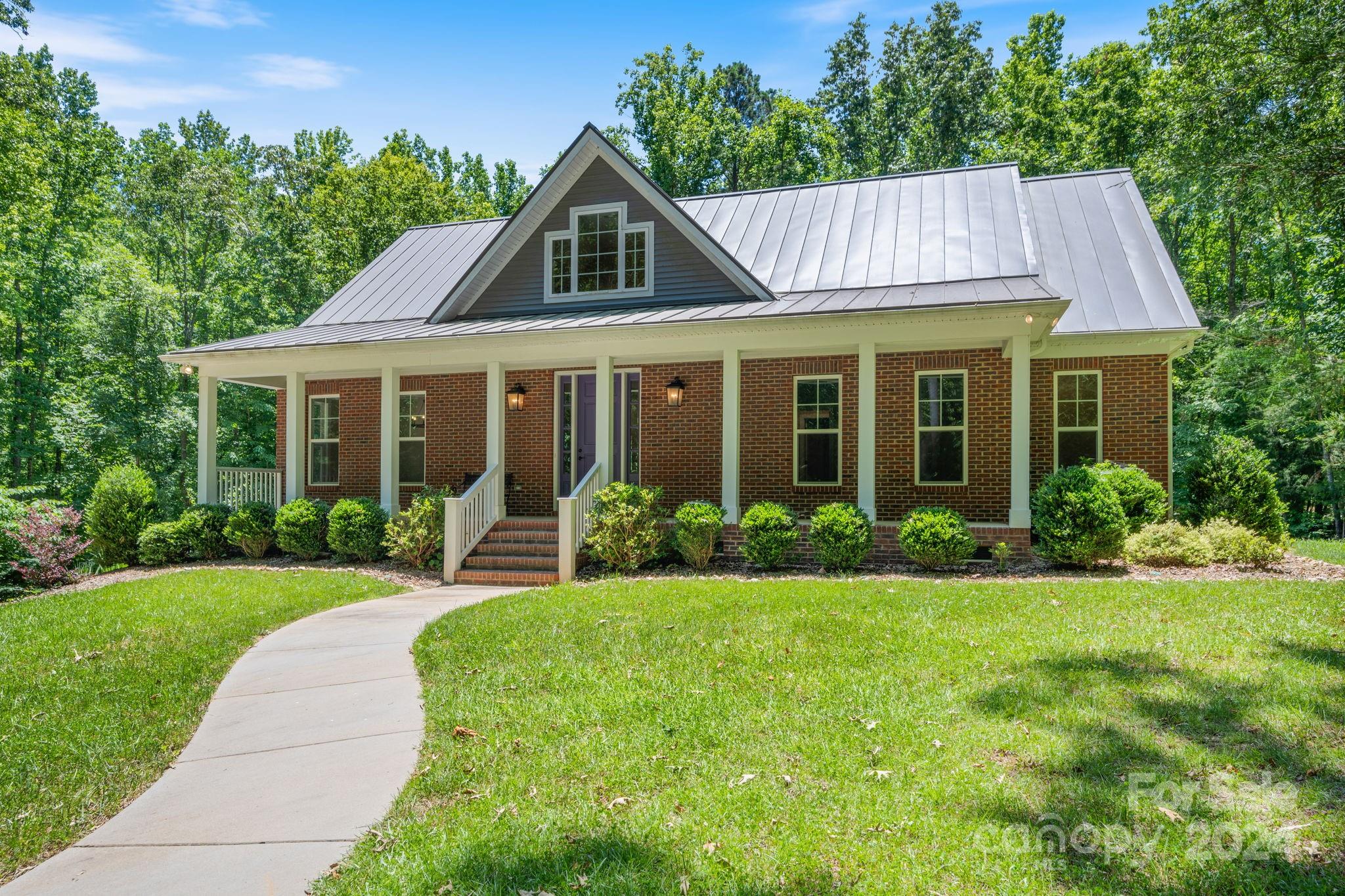 Welcome to Quiet Creek, a small community of estate sized lots of 5 acres or more, conveniently located with close proximity to both Waxhaw and Lancaster. 1297 Quiet Creek sits on 8.59 acres and was designed with convenience, energy efficiency and privacy in mind by the current owners and custom built by a renowned local builder in 2018. It offers an owner's suite on the main floor along with an office/bedroom, family room w/ vaulted ceiling, built-ins and stacked stone fireplace, dining room and generously sized kitchen. Upstairs includes two large bedrooms, a full bath and multiple storage closets as well as walk-in attic storage. The lower level includes a three car finished garage as well as 900+ square feet of unfinished living area framed for game room, media room, additional bedroom and bathroom including plumbing stub-out. Energy upgrades include spray foam, supplemental solar power system producing the majority of the energy needs for the home, hybrid hot water system.