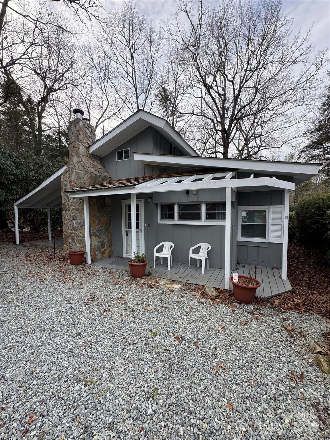 Pulling into the Driveway you notice the beautiful stone chimney. From the moment you walk through the front door, you will appreciate the care and attention to detail in this charming two-bedroom, one-and-a-half-bath Land Harbor cottage. The original RV park model has been completely remodeled to include a half bath, a laundry area, and a primary bedroom. The updated kitchen is sure to impress with updated appliances coffee bar, and generous pantry storage. Here you also find the dining area. The large living room offers the option to reinstall a wood-burning stove or gas fireplace kit; the flue is still intact. The current propane heater now provides comfort on chilly evenings, giving ambiance of a cozy fire. Multiple skylights brighten the home with abundant natural light. The guest bedroom features ample windows and a Murphy bed that conveniently tucks away, if needed. You’ll appreciate the original hardwood floors in this part of the home, and the owner notes that the same flooring continues beneath the carpet in the living room. Luxury vinyl plank flooring has been added to the remodeled areas. The full bathroom includes a stand-up shower, granite countertops, and plenty of storage, including a utility closet. Upstairs, you’ll find a large attic space with windows and an area that could potentially be converted into additional space with a bit of creativity. Built-ins throughout the home add to its charm, making this Land Harbor property a must-see. Outside, you will find a covered patio/carport area with walk around decking leading to an open entertaining back deck. Ample parking is also provided at this home. Location is within walking distance to the Golf House and Patio Grill. POA dues include swimming pool, water, sewer, cable tv, internet, 24/7 security, trash collection and road maintenance. SOLD Completely Furnished!