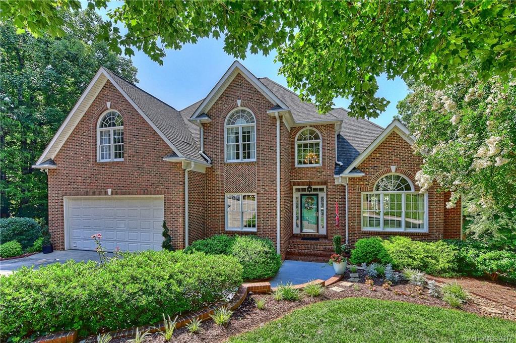 Wow! Hard to find updated 6 BR, 4.5 BTH 2 story with basement on almost 1 acre lot backing to the end of a cove in the Anchorage subdivision in Tega Cay.  Need garage space? Can do! Four car garage with more storage and workshop area. Great stay-cation home with a heated pool, spa, volleyball court.   Model perfect home has been remodeled and offers a master BR on the  main level. Very open floor plan. Great outdoor living with oversized double decks. Unique opportunity! No water access.